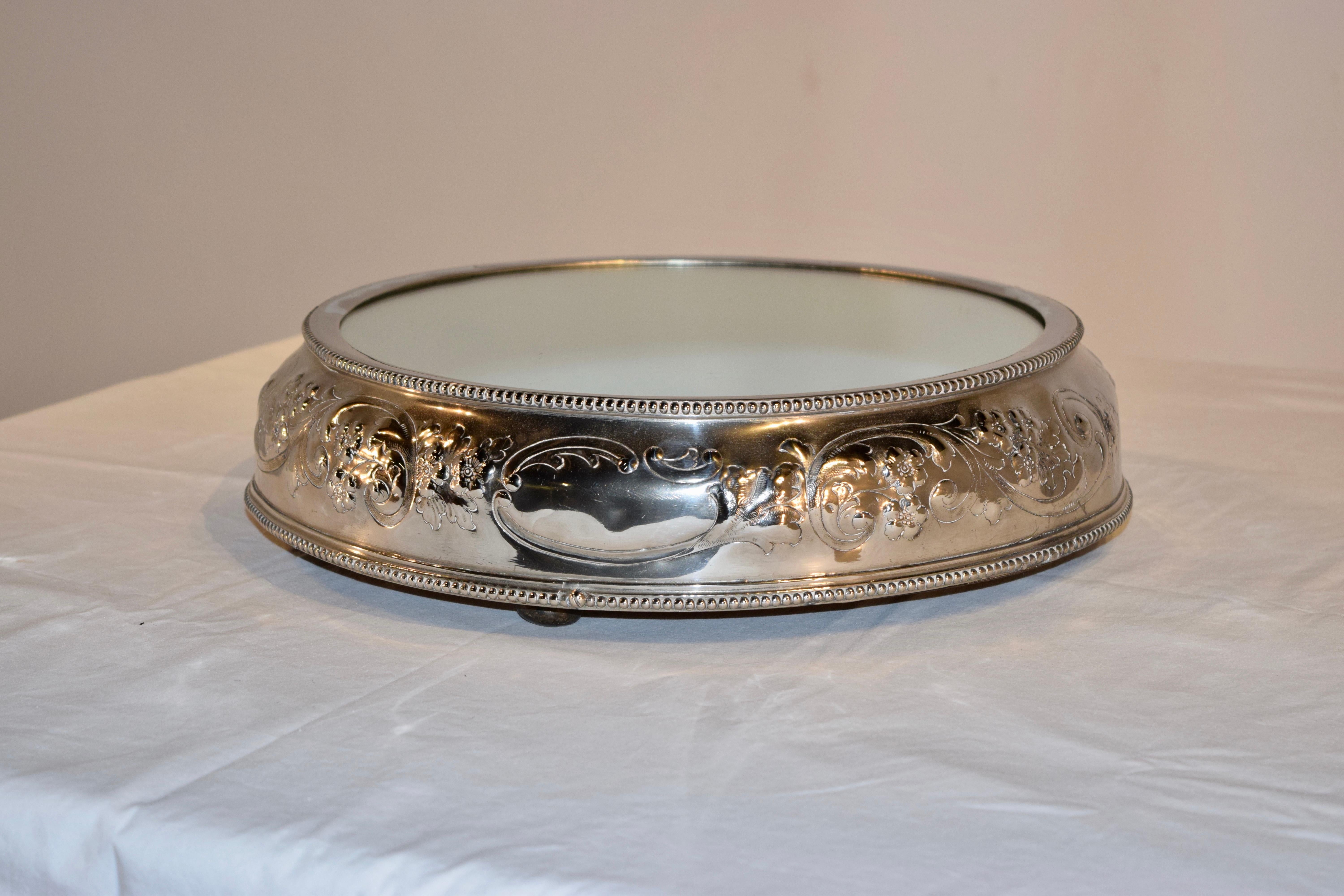 Silver plated plateau with a mirrored top and a lovely hand embossed base. It was a trophy won by Wm Gegg from Scarborough in England.