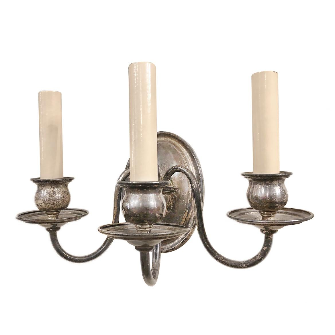 Pair of circa 1920's English silver-plated three-arm sconces.

Measurements:
Height: 7