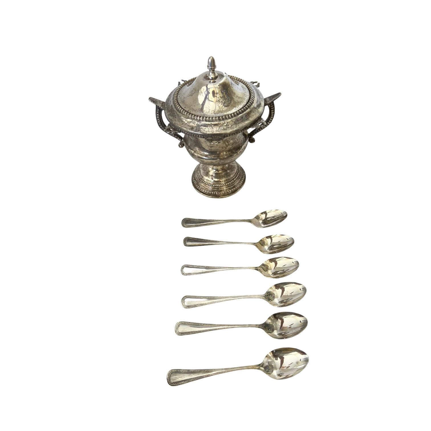 A silver plated sugar or serving bowl with six hanging spoons. An unusual piece sure to be a conversation starter.