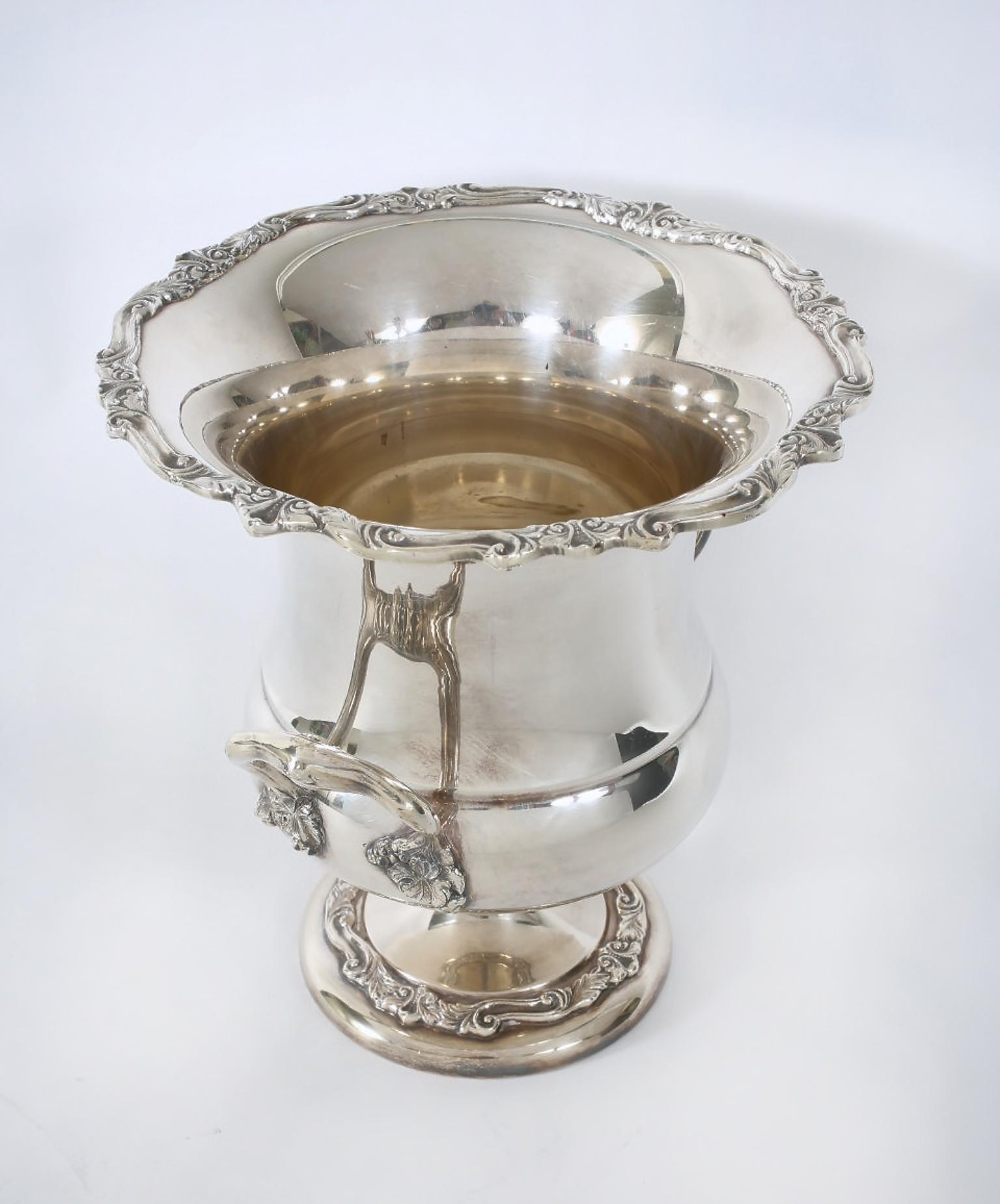 English silver plated wine cooler / ice bucket with side handles and exterior design details. The bucket is in great vintage condition with wear consistent with age / use. Maker's mark undersigned. It stands about 10.5