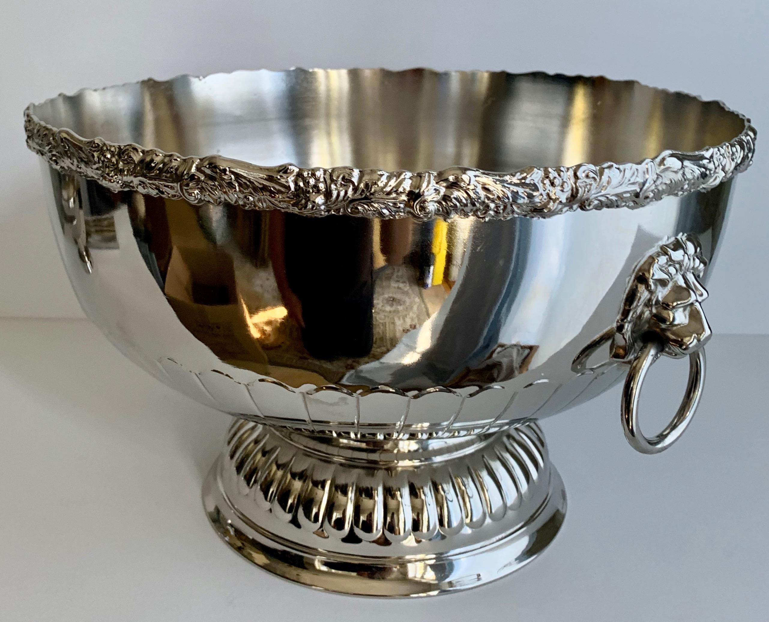 English silver punch bowl with rim and lion handle details - freshly plated punch bowl, silver over copper, made in England. Stamped on Bottom.

A handsome bowl for punch, cooling Champagne or a wonderful holder for flowers or fruit on any table -