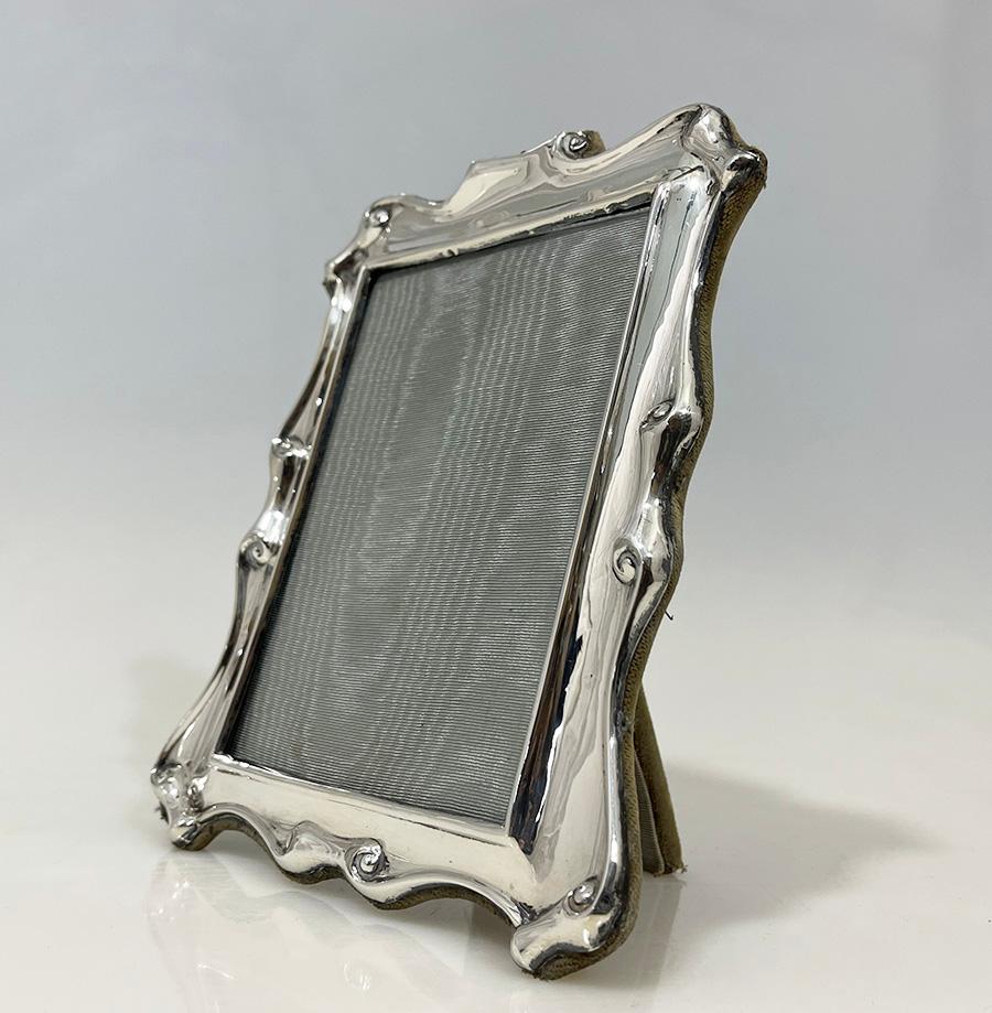 English silver rectangular Photo/ Picture Frame by E.J. Trevitt & Sons, 1915

English rectangular silver photo frame with scroll pattern and glass, made by E.J. Trevitt and Sons
Thin silver attached on a velvet backside 
The silver frame is