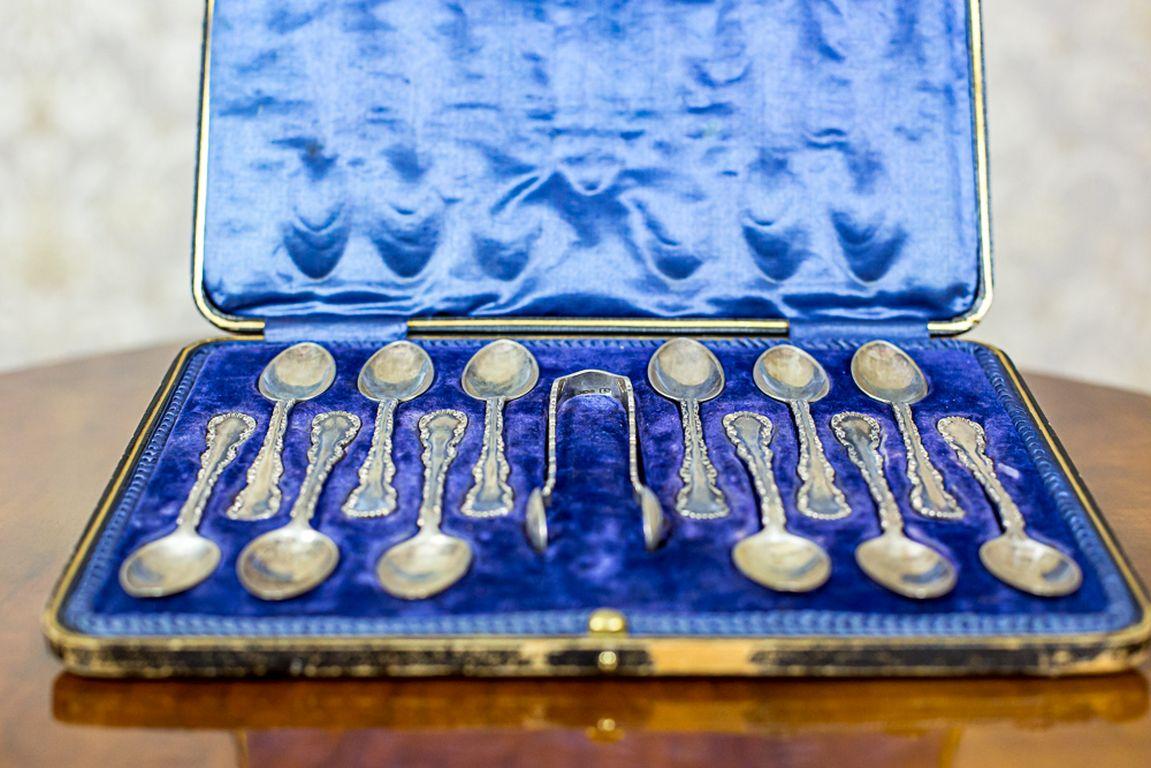 The set includes 12 teaspoons and sugar tongs.
The whole is in the original case padded with satin.
Presented items are made of silver. The hallmarks and the makers’ marks are stamped on the inside of every teaspoon’s small bowl.
A distinct assay