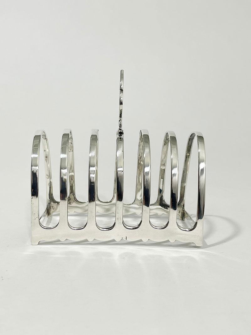 English silver toast rack by Gorham Manufacturing Co., Birmingham 1919

A Silver toast rack for 6 slices of toast
Made by Gorham Manufacturing Co. in Birmingham (1904-1938)
Silver Hallmarks of England Lion, the Anchor of Birmingham, Year letter