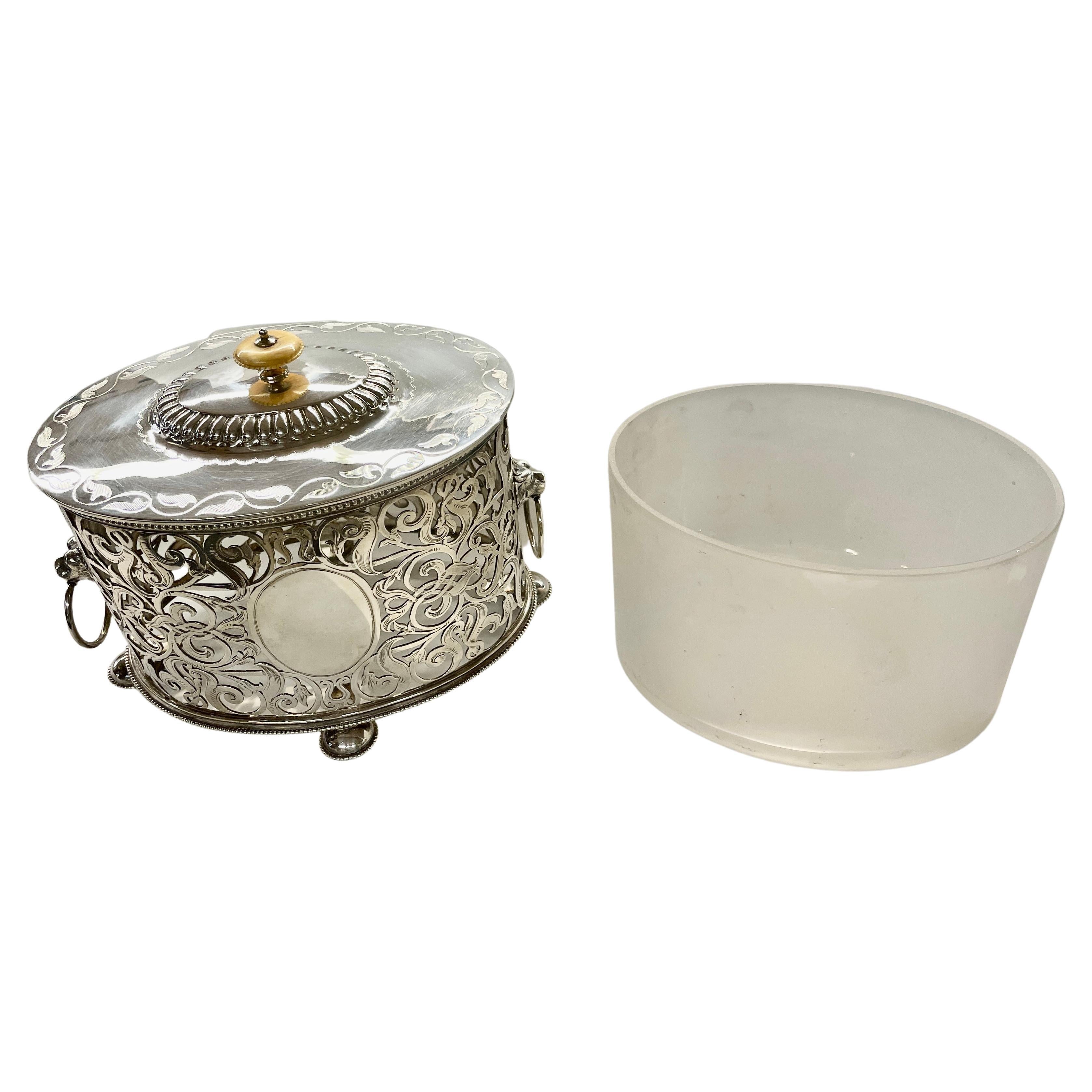 Finest quality antique English silverplate Regency style exceptionally hand pierced and engraved oval biscuit box with original frosted glass liner and carved bone finial. This oval biscuit box is not only fabulously hand pierced, but the pierced