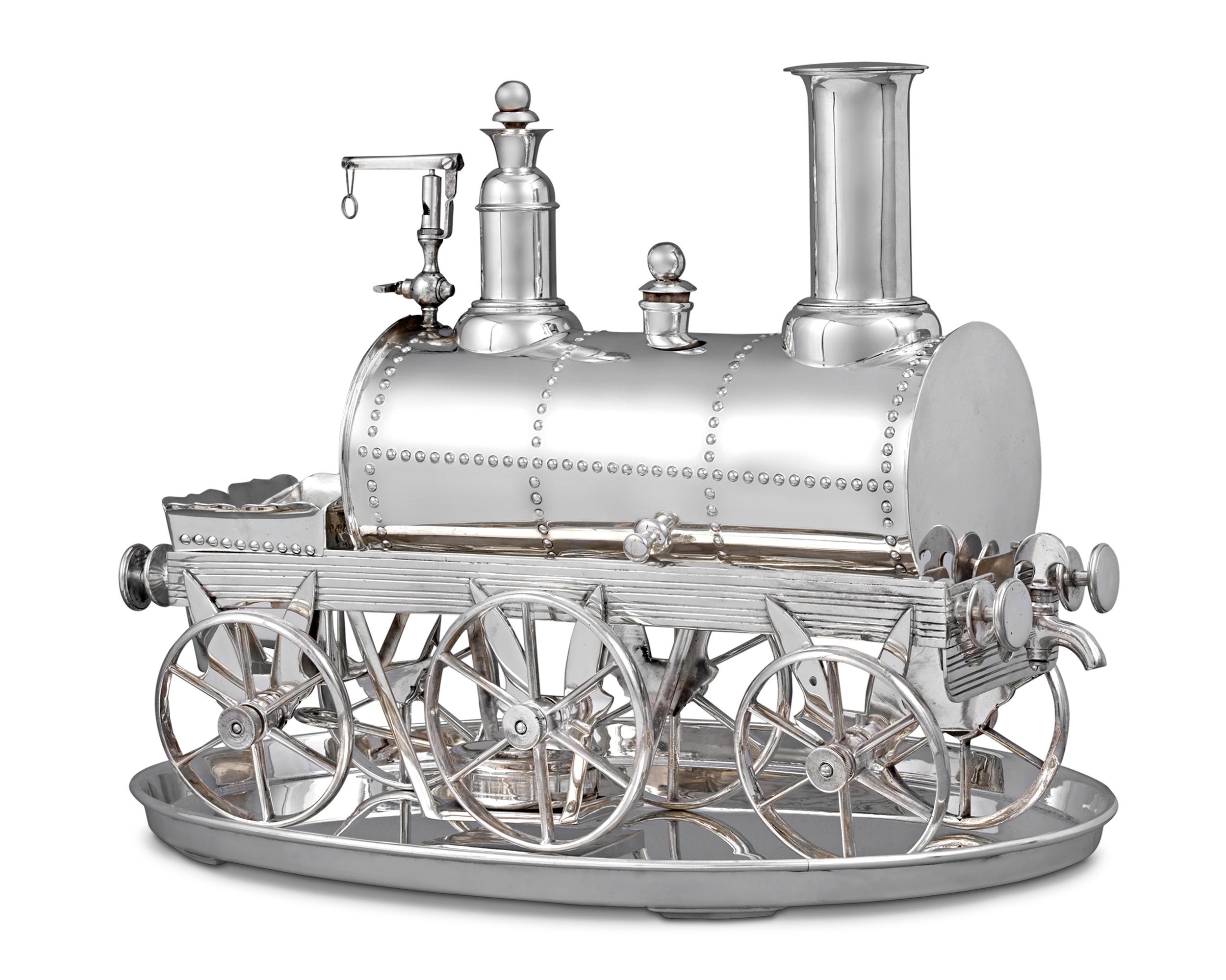 This exceptionally rare English silverplate tea urn takes the playful form of a locomotive. Made to heat and dispense tea, the urn features an opening for tea and an opening for hot water, as well as a container to store sugar cubes. Meticulously