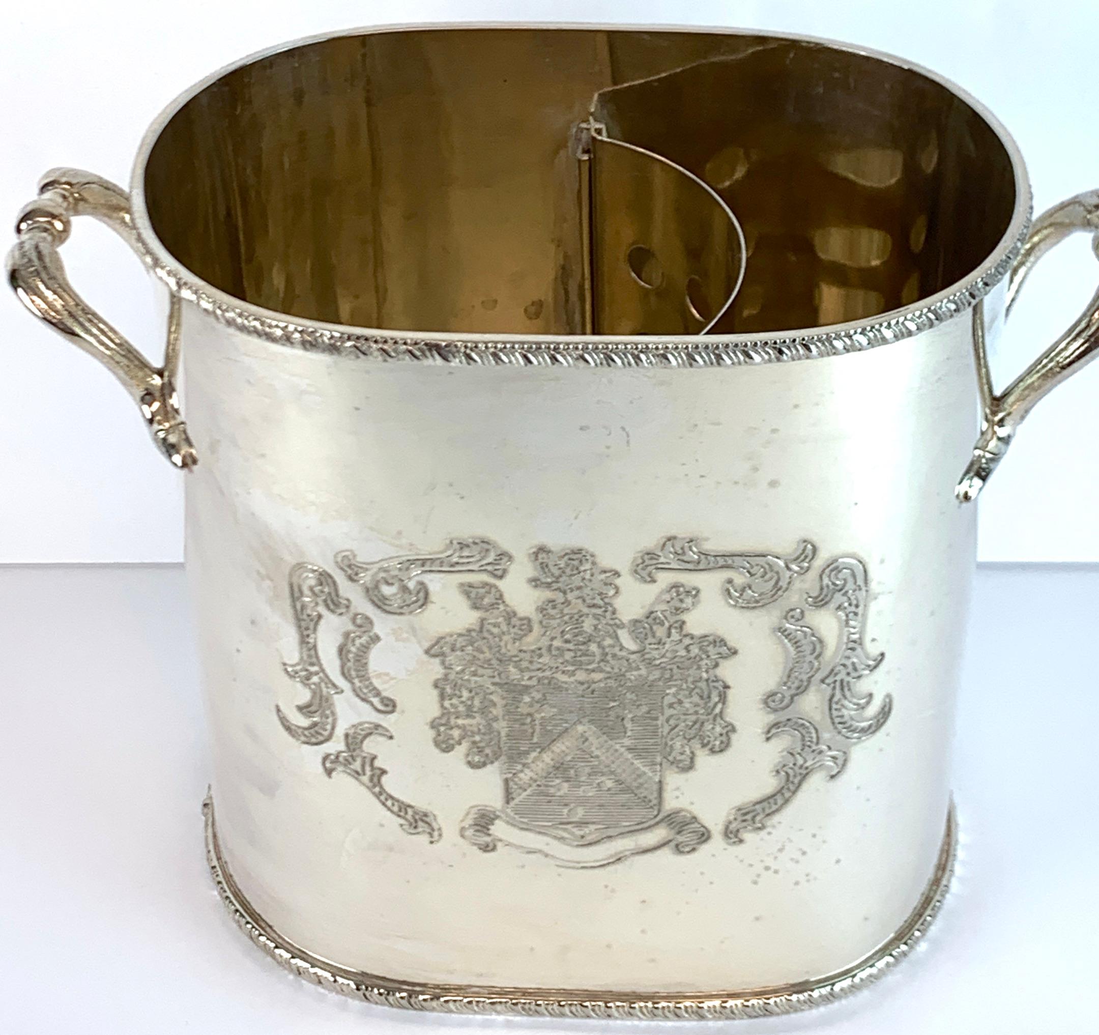 English silver plated armorial oval wine cooler, handled, with removable pierced bottle caddy, the interior measures, 8.5