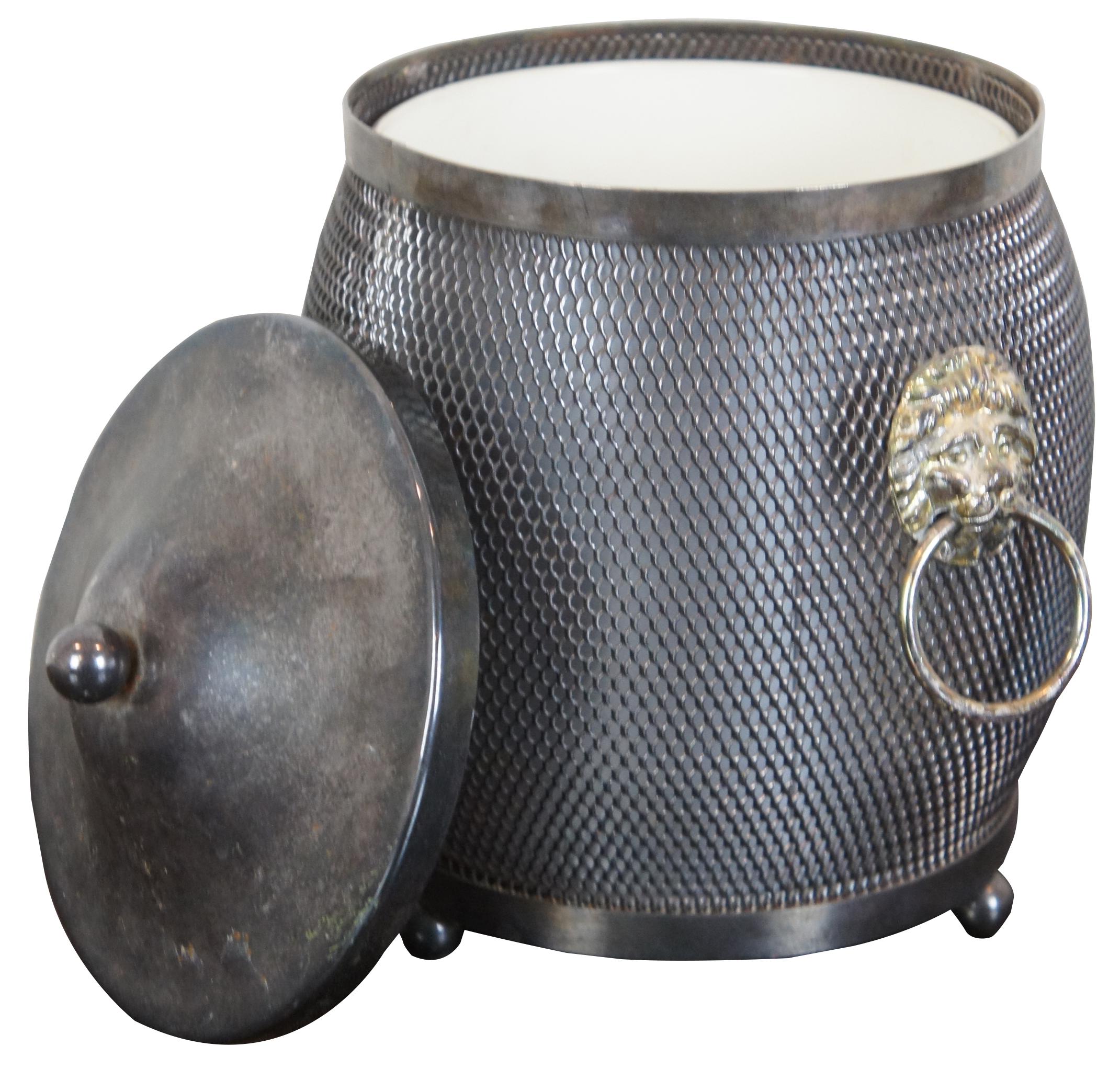 Vintage made in England biscuit barrel, tea caddy or small ice bucket made of metal mesh with shield accent (no monogram) and lions head handles. Includes tin insert. Measure: 8