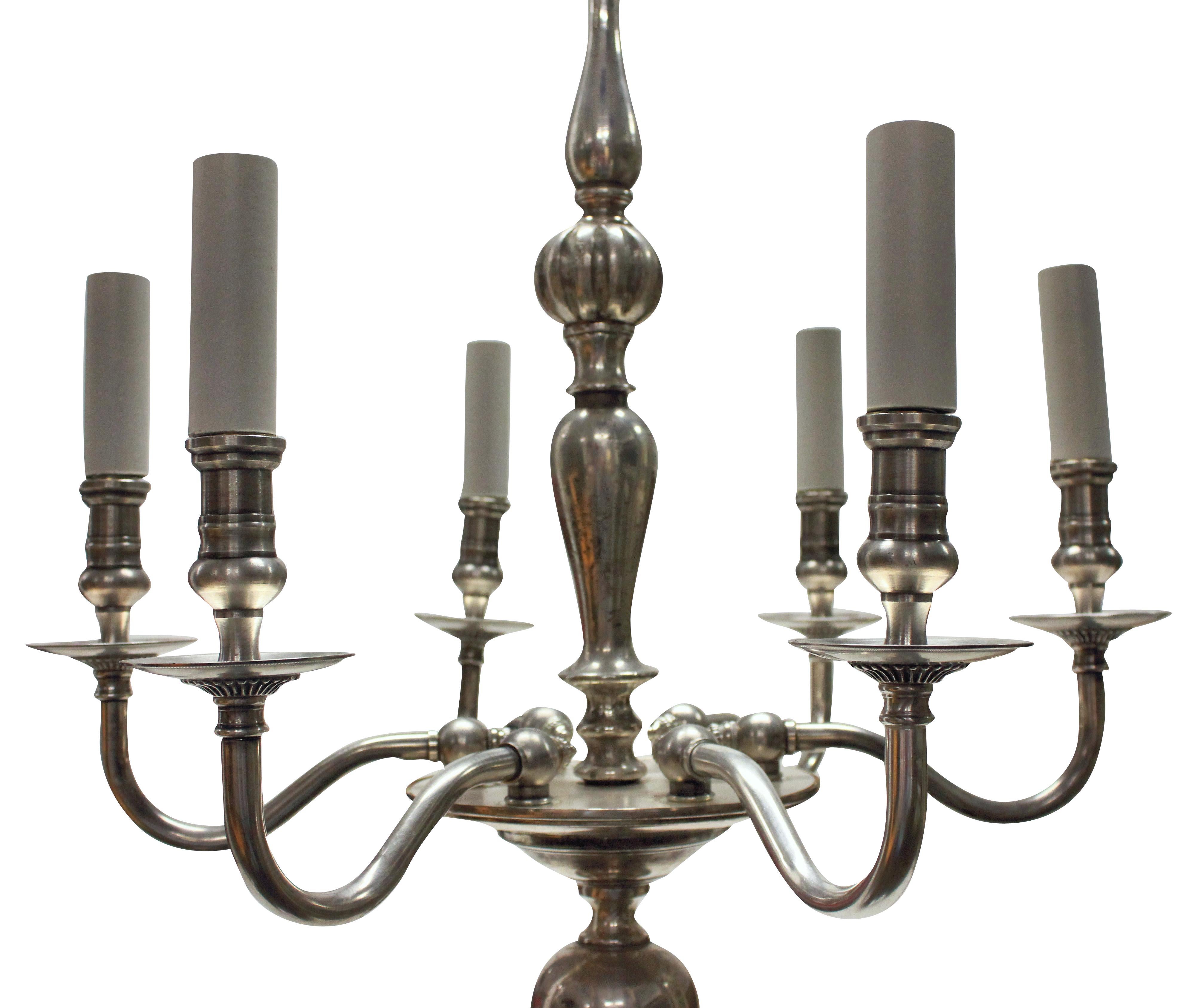 An English, silver plated chandelier of simple form with six upswept arms.