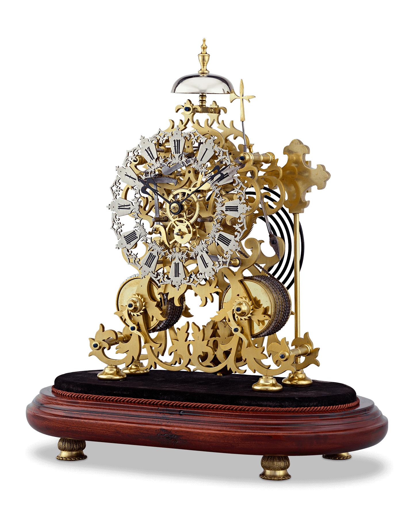 This exceptional two-train English skeleton clock was crafted by the celebrated clockmakers J. Smith & Sons of Clerkenwell. The beautifully designed floral scroll frame incorporates an ivy motif, which perfectly complements the Gothic-style pierced