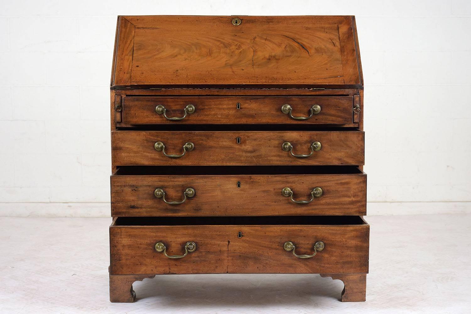 This circa 1820s English Slant Front Secretary Desk is made of walnut wood with the original finish and has been newly waxed & polished giving it a  beautiful patina finish. The piece has two arms that extend from the front of the desk to support