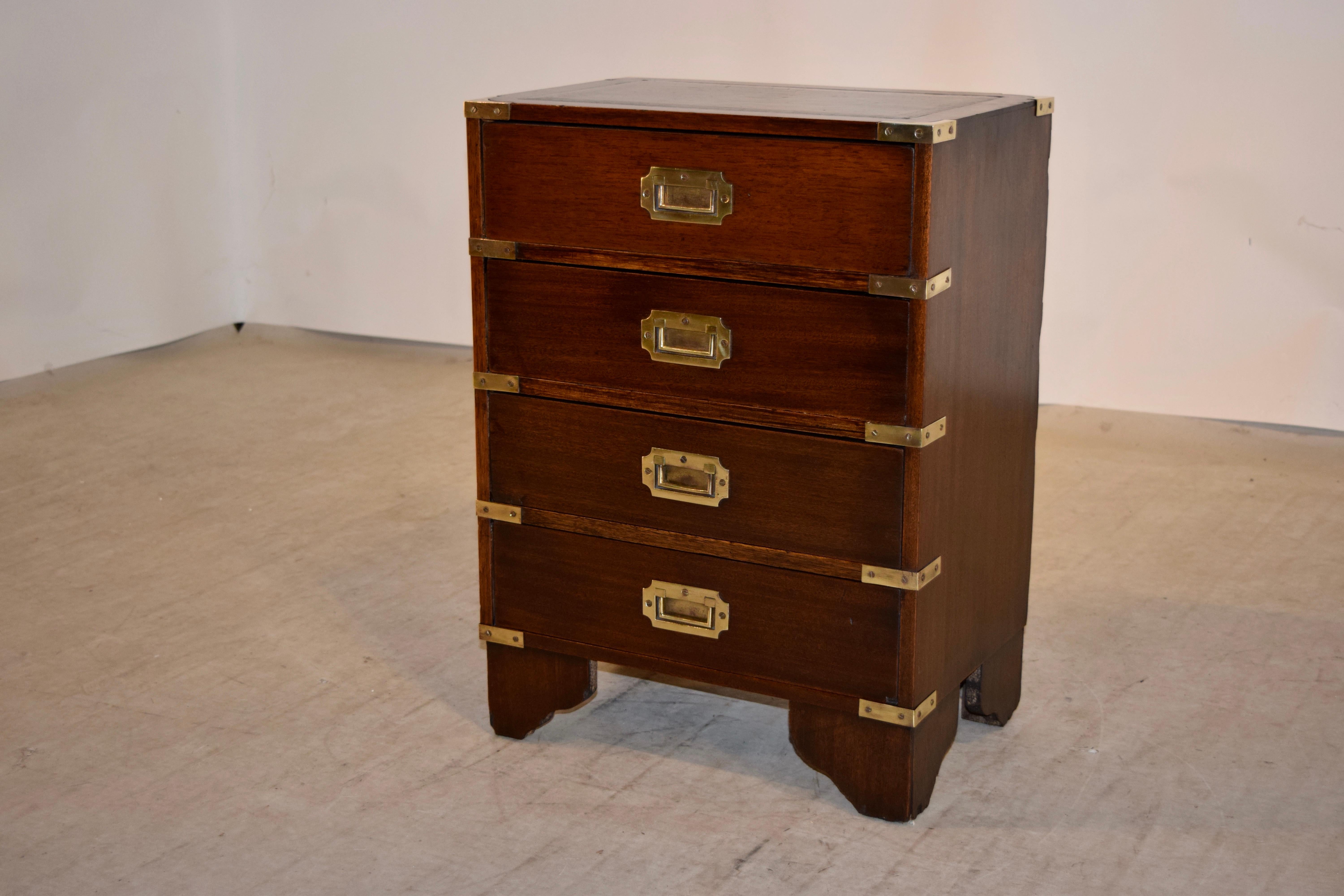 English mahogany small campaign chest with brass banding and hardware. Raised on bracket feet.