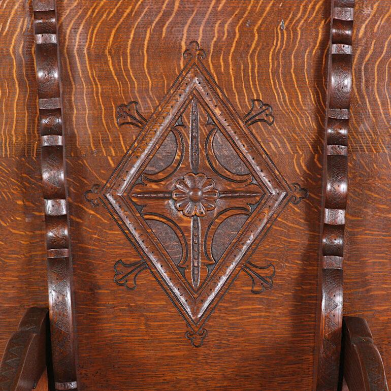 An English, carved, metamorphic Monks Table-Chair in solid oak. The round top folding up to become the back of a chair. A sturdy, handsome piece with lovely quarter-sawn oak grain and warm patina.