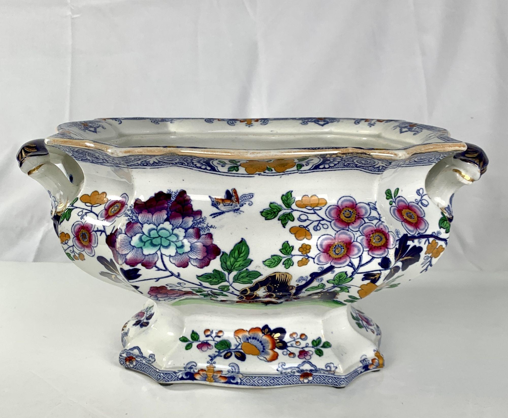 Made by Hicks and Meigh circa 1820, this lovely tureen is perfect for flowers. 
The lively decoration is full of color. 
We see a butterfly hovering above a flower-filled garden.
Pink fruit tree blossoms and purple peonies rise above cobalt blue