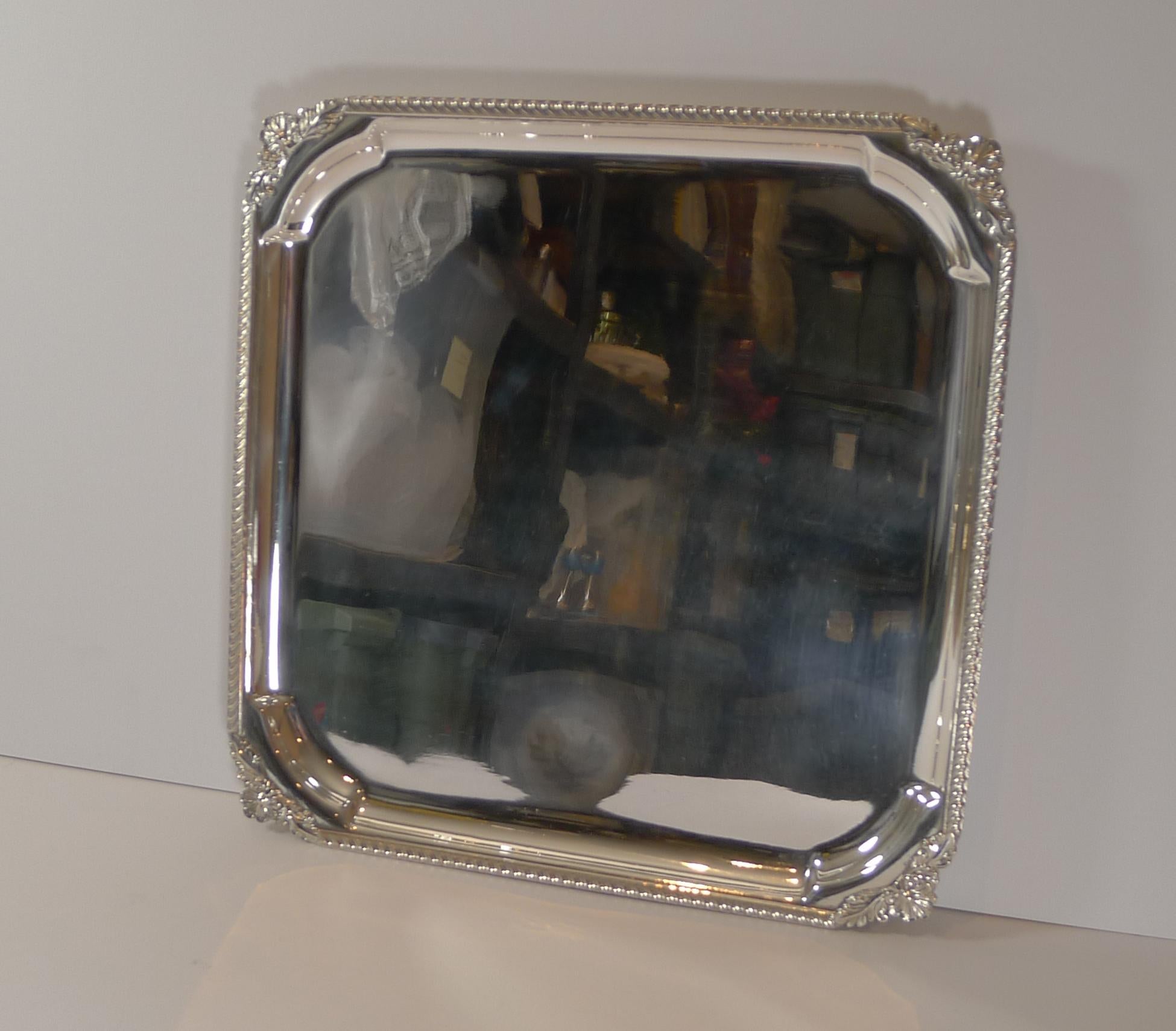 A fine English silver plated square tray or salver, perfect to serve drinks and a perfect bar accessory.

The underside is where the Pineapple mark can be found for Barker Ellis and dates to the Art Deco era, around 1930's. Always very