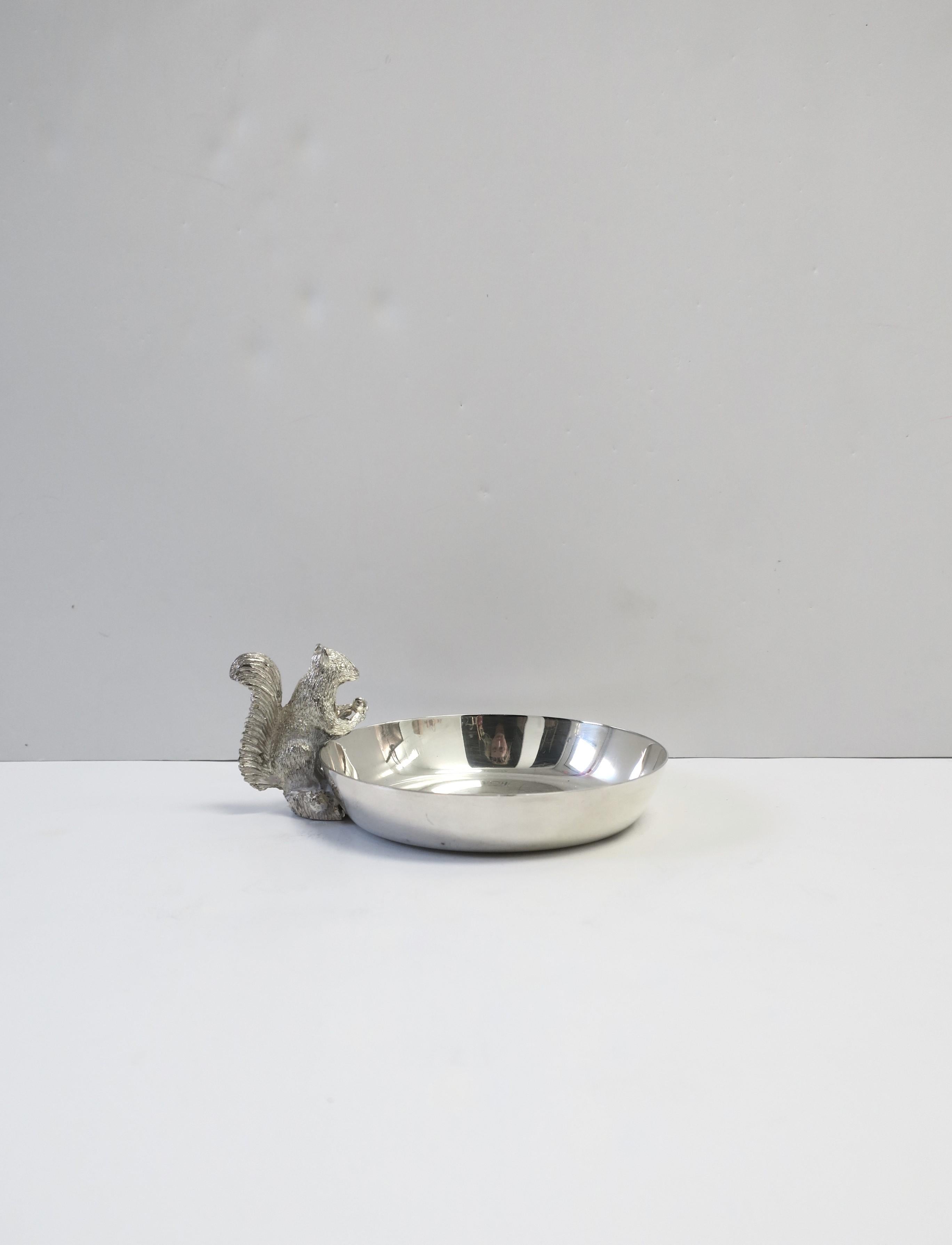 A small but substantial English sterling silver plate squirrel nut bowl, circa late-20th century, England. Piece is solid copper with sterling silver plate overlay and a detailed squirrel on the side of this small bowl. Piece is marked 'Made in