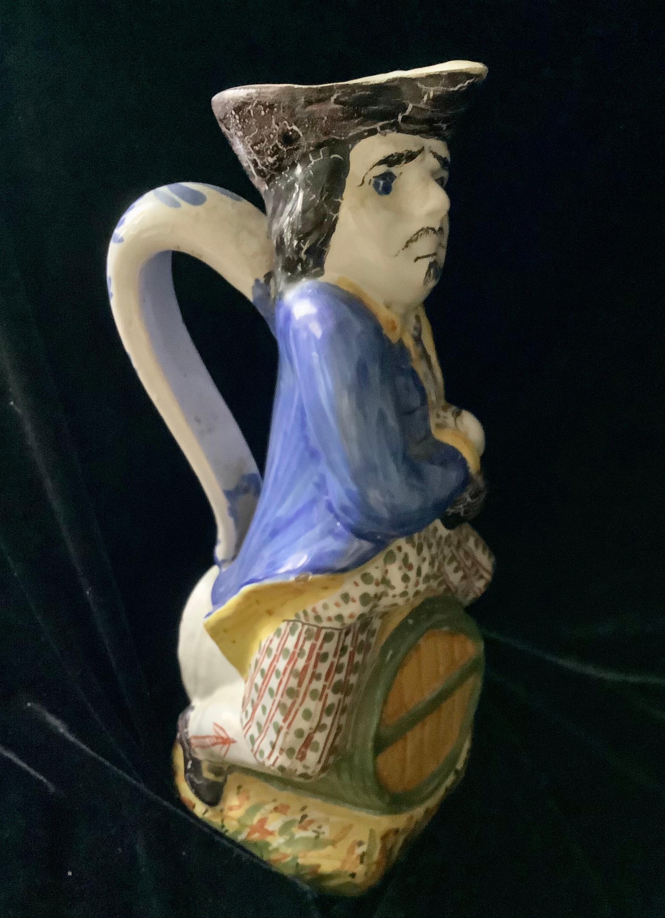 English Staffordshire ceramic Toby Jug figure with jug in right hand and sitting on a barrel. 
