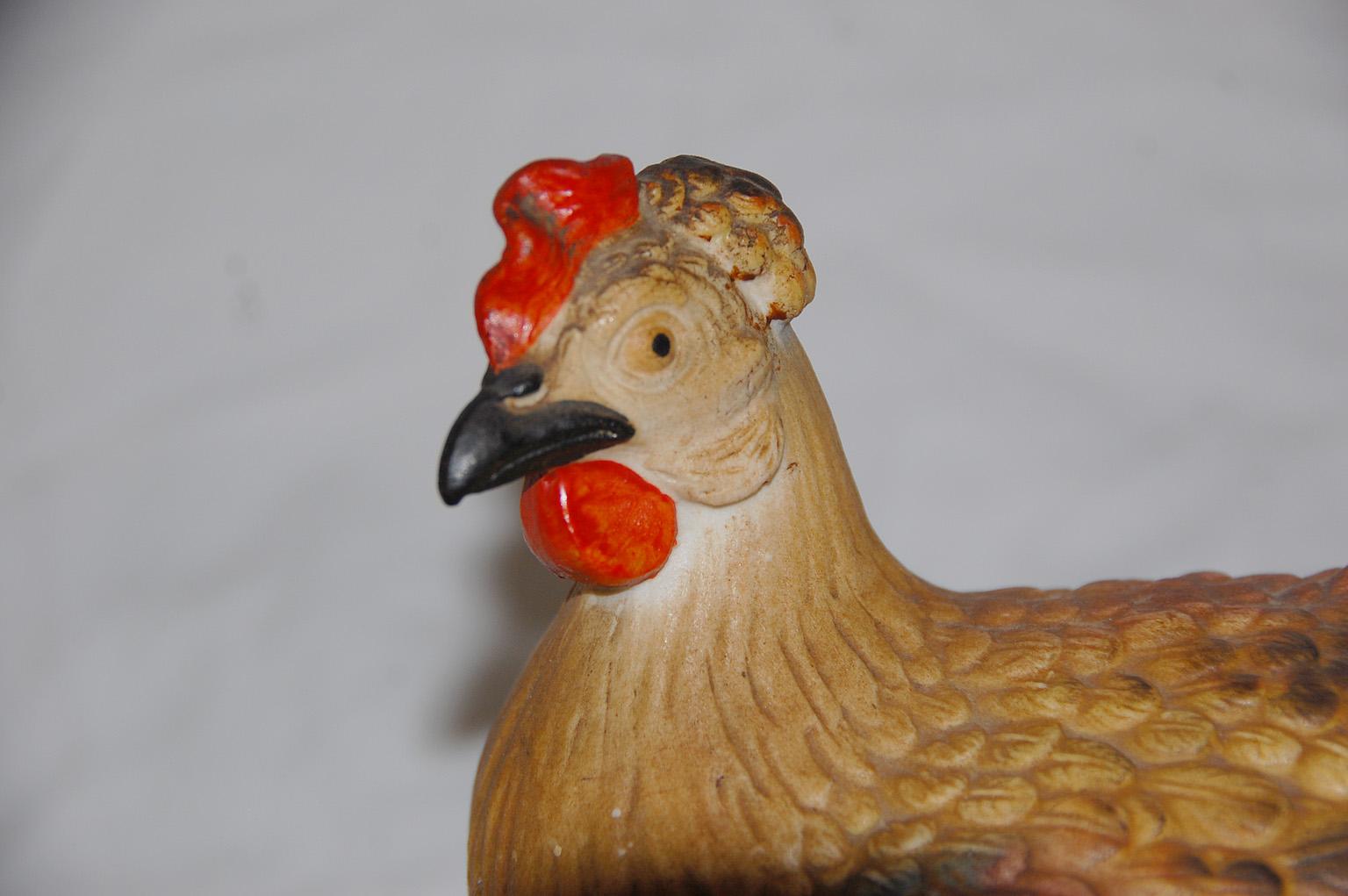 This English staffordshire ironstone chicken on a basket has been beautifully molded, fine detail to the feathers, eyes and head. The two part chicken on a basket is all hand painted, the basket being in a lustre glaze, the chicken being in a mat