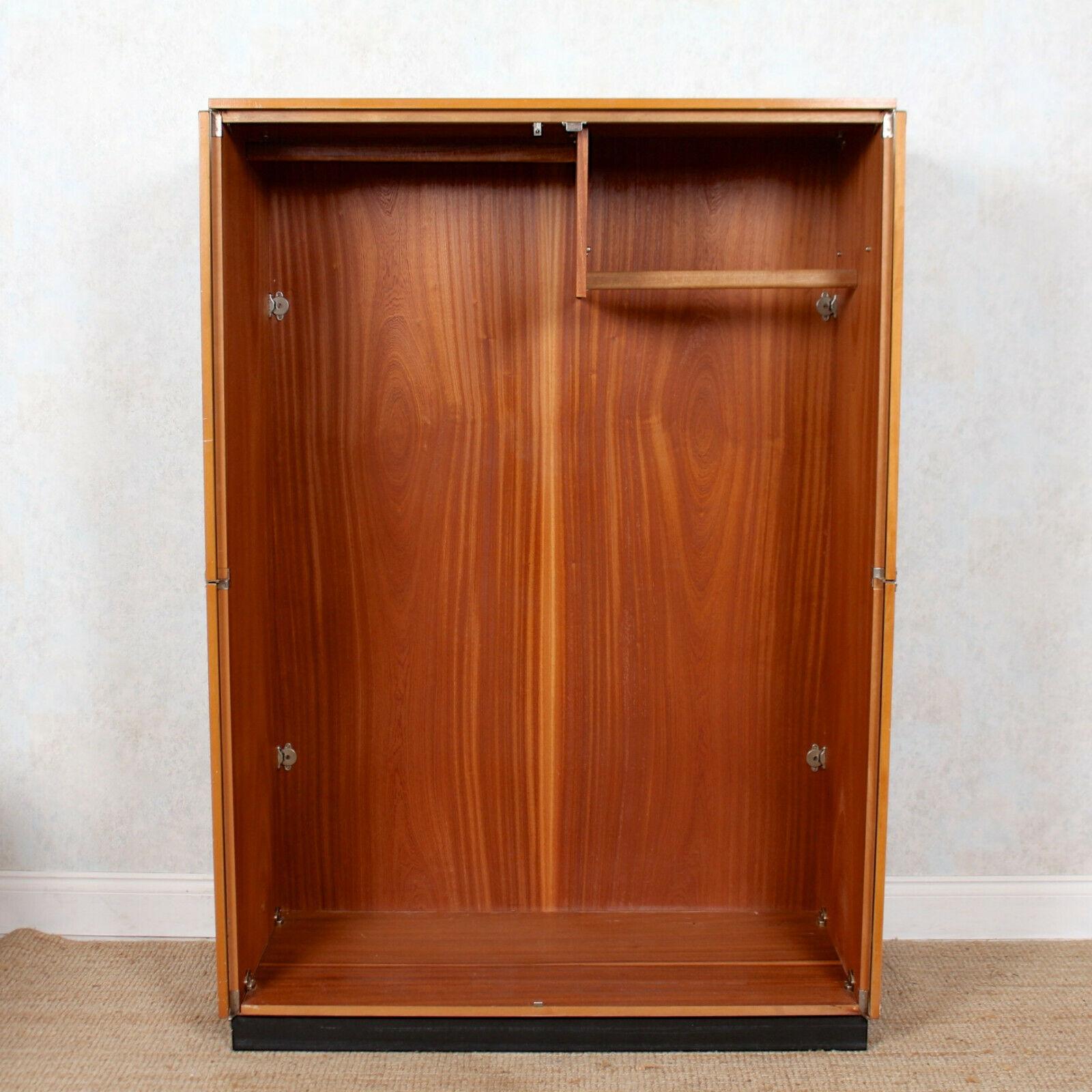 An impressive and rare model double wardrobe by Stage.
The fully retractable doors, mounted with good original handles, enclosed two hanging rails and raised on an ebonized plinth base.
England, circa 1975.