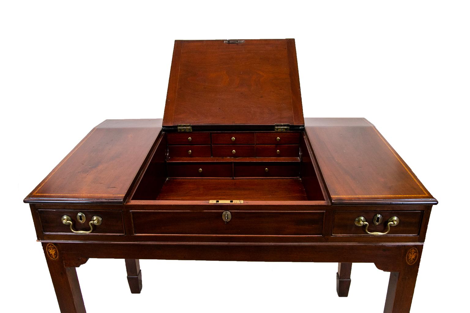 The top of this English stand up desk with lift top is inlaid with boxwood and ebony line inlay framed by bullnose molding on all four sides. The back side is finished and inlaid. The top section has exposed dovetailed construction. The center