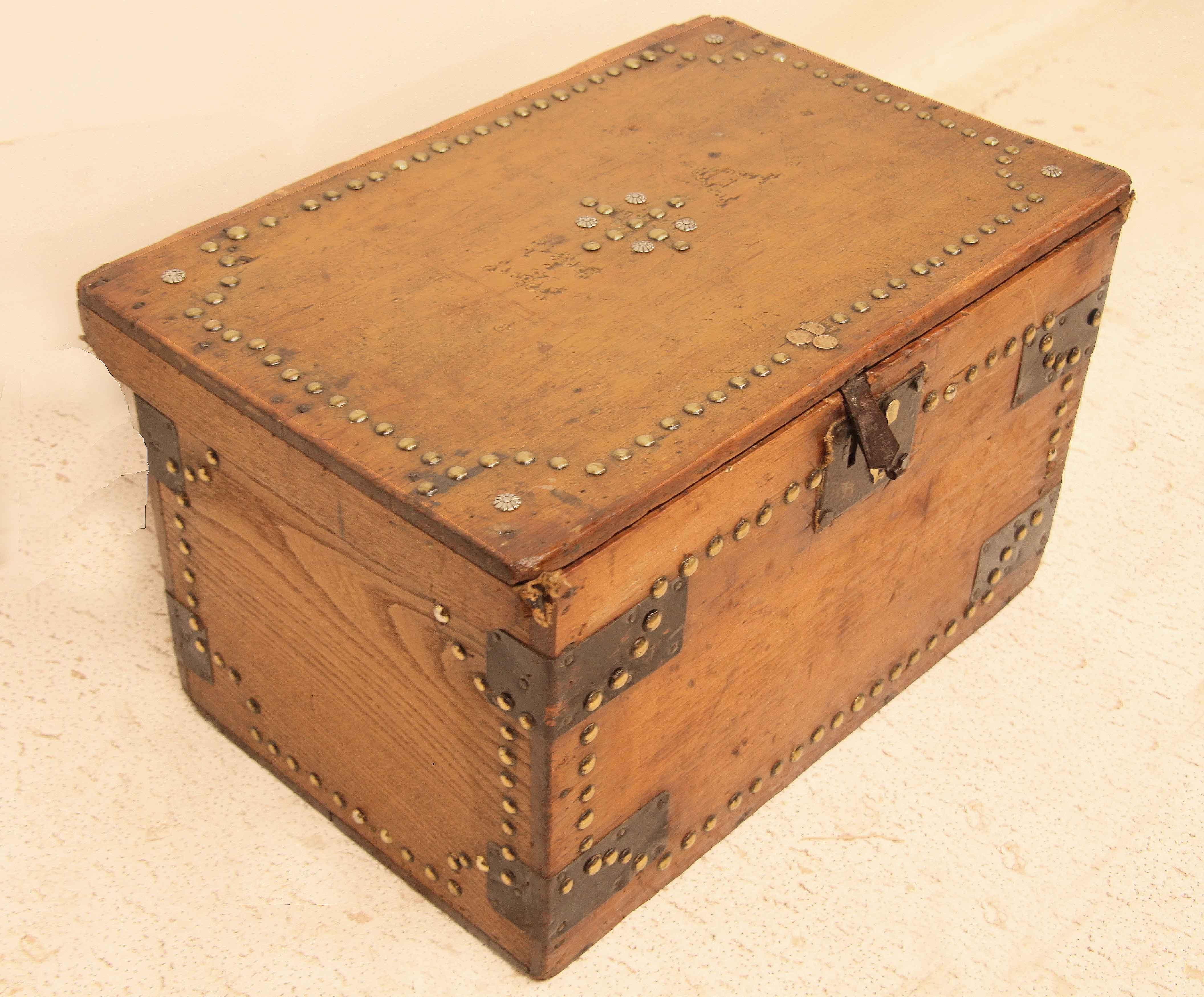 English steel bound pine box, the front and sides are secured with steel bindings, the top, front and sides are decorated with brass buttons ( nail heads ) , the top has brass buttons in the center with remnants on each side of the initials 