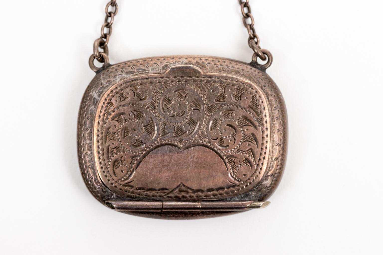 Circa early 20th century Sterling silver makeup compact crafted in Birmingham, England. The piece is detailed with scrolled foliage on the case exterior and comes with a puff. Weight 1.5 grams with mirror. Please note of wear consistent with age