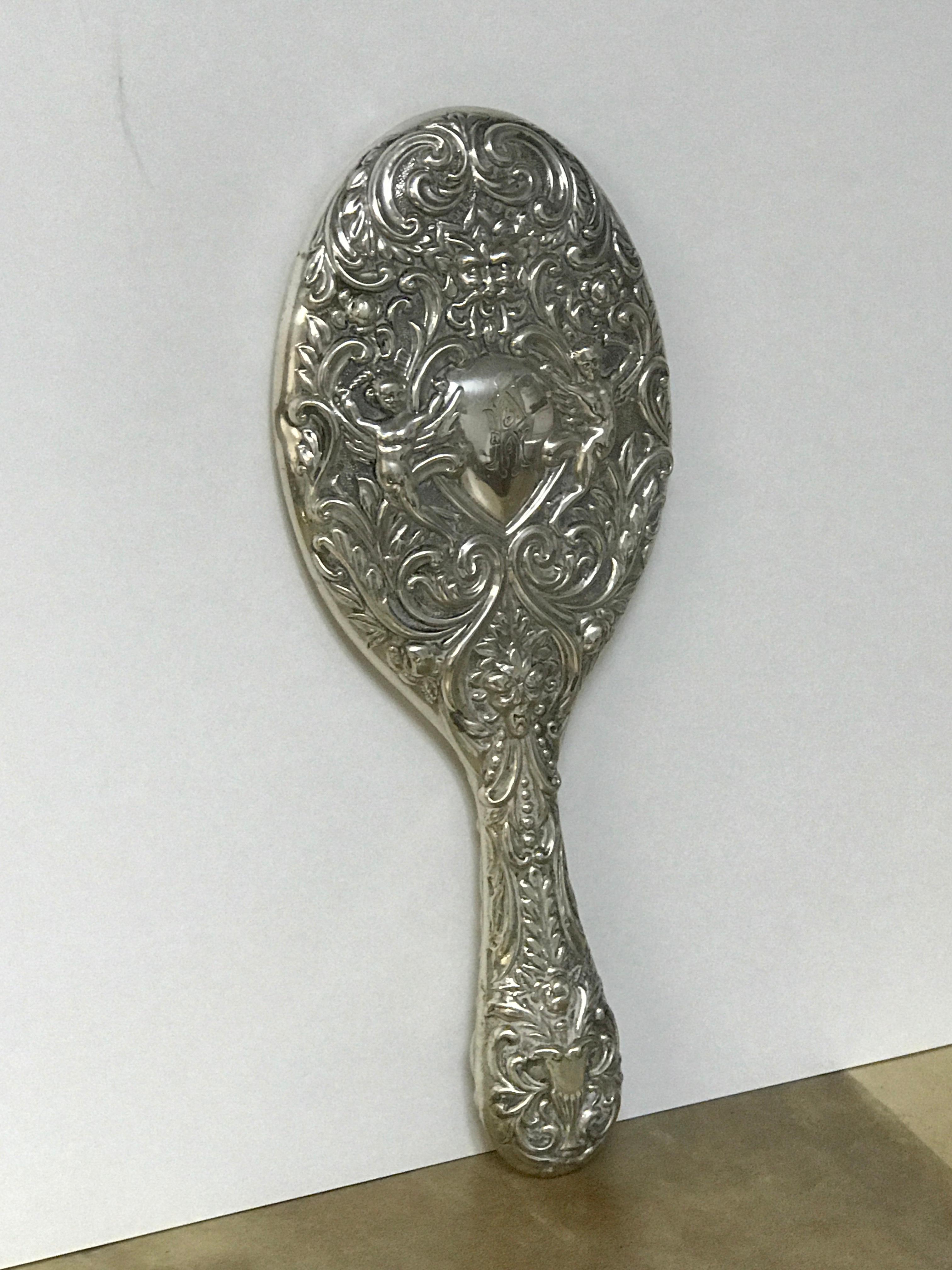 English Sterling Hand Mirror, Birmingham, 1899

Indulge in the luxurious charm of late 19th century elegance with this beautiful English sterling hand mirror. Exquisitely crafted in Birmingham 1899, the mirror is a perfect testimony to High