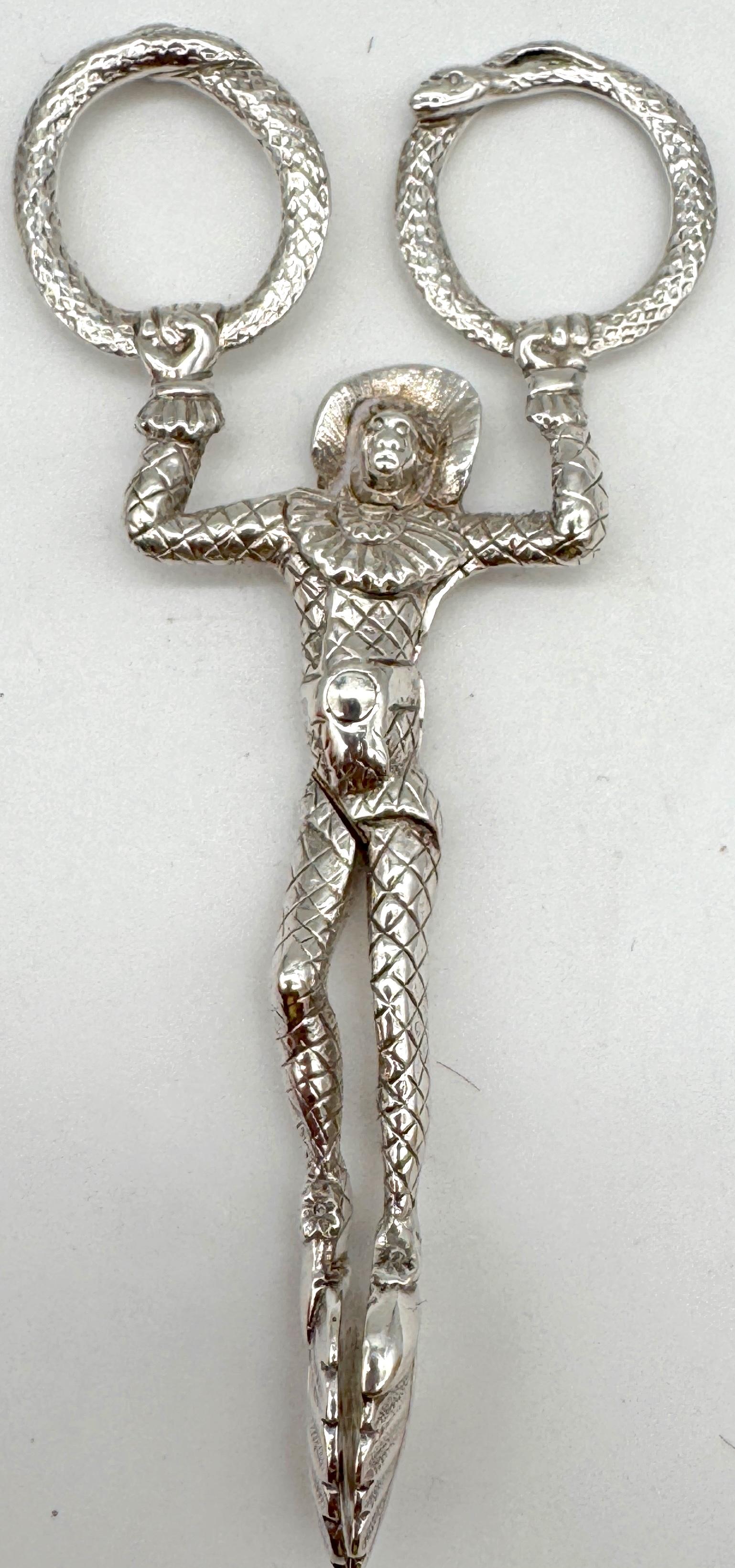 Victorian Sterling Silver Jester & Ouroboros Snake Sugar Tongs, Birmingham 1887, by Joseph Willmore

An extraordinary example of Victorian novelty silver, this figural pair of sterling sugar tongs was crafted in Birmingham in 1887 by Joseph