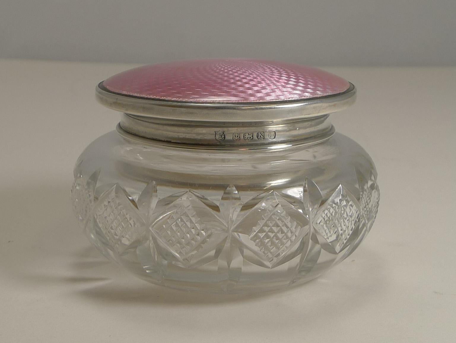 This pretty vintage English powder bowl or box is made from a hefty piece of English crystal with a deep handcut design.

The bowl is covered with a sterling silver lid fully hallmarked for Birmingham 1934. The lid fits well with the original