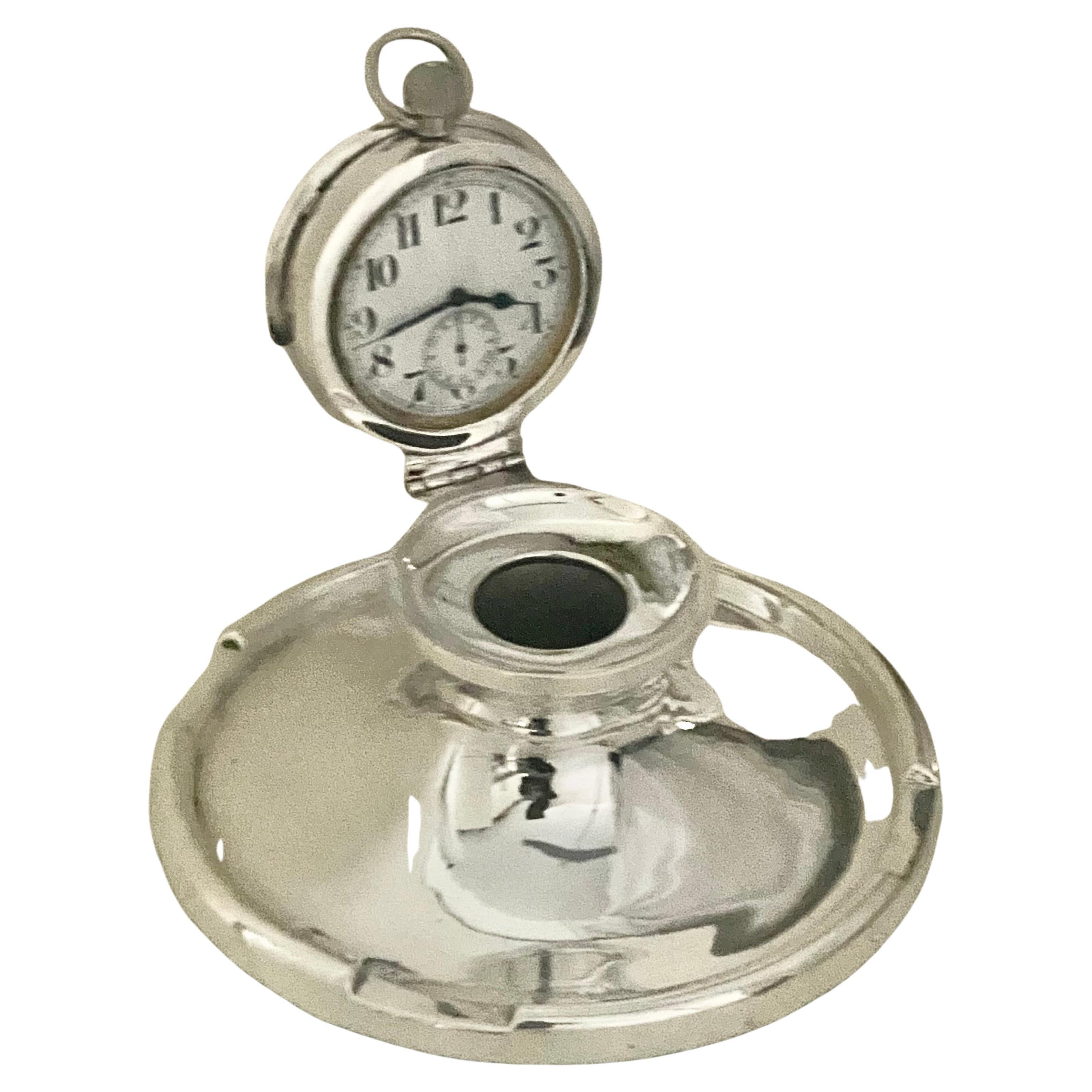 Very highly sought-after, this is a lovely example of an inkwell with the pocket watch lid. Made from sterling silver, the inkwell is hallmarked forBirmingham 1906, Edwardian in era. 
The watch is the original and has been overhauled and cleaned by