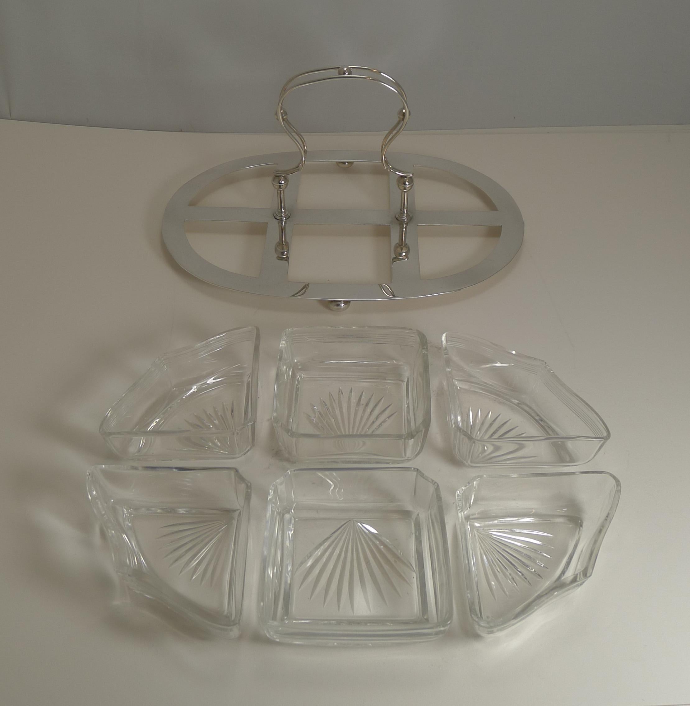 A most unusual vintage serving set, unusually made from sterling silver rather than silver plate, signed by the top-notch Sheffield silversmith, James Dixon and Sons.

The frame is fitted with the six original cut crystal dishes and come complete