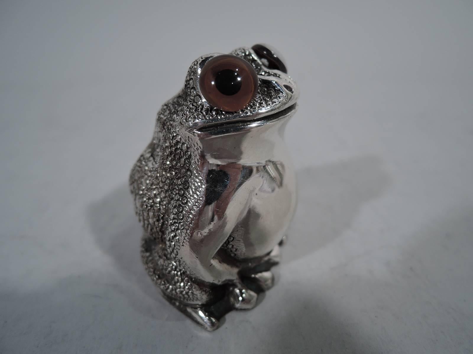George VI sterling silver frog shaker. Made by Asprey in London in 1947. A squatting reptile with legs gathered close to body. Scaly back, smooth front, and intense glass exophthalmic eyes. Closed mouth set in smirking smile. A cute solo companion.