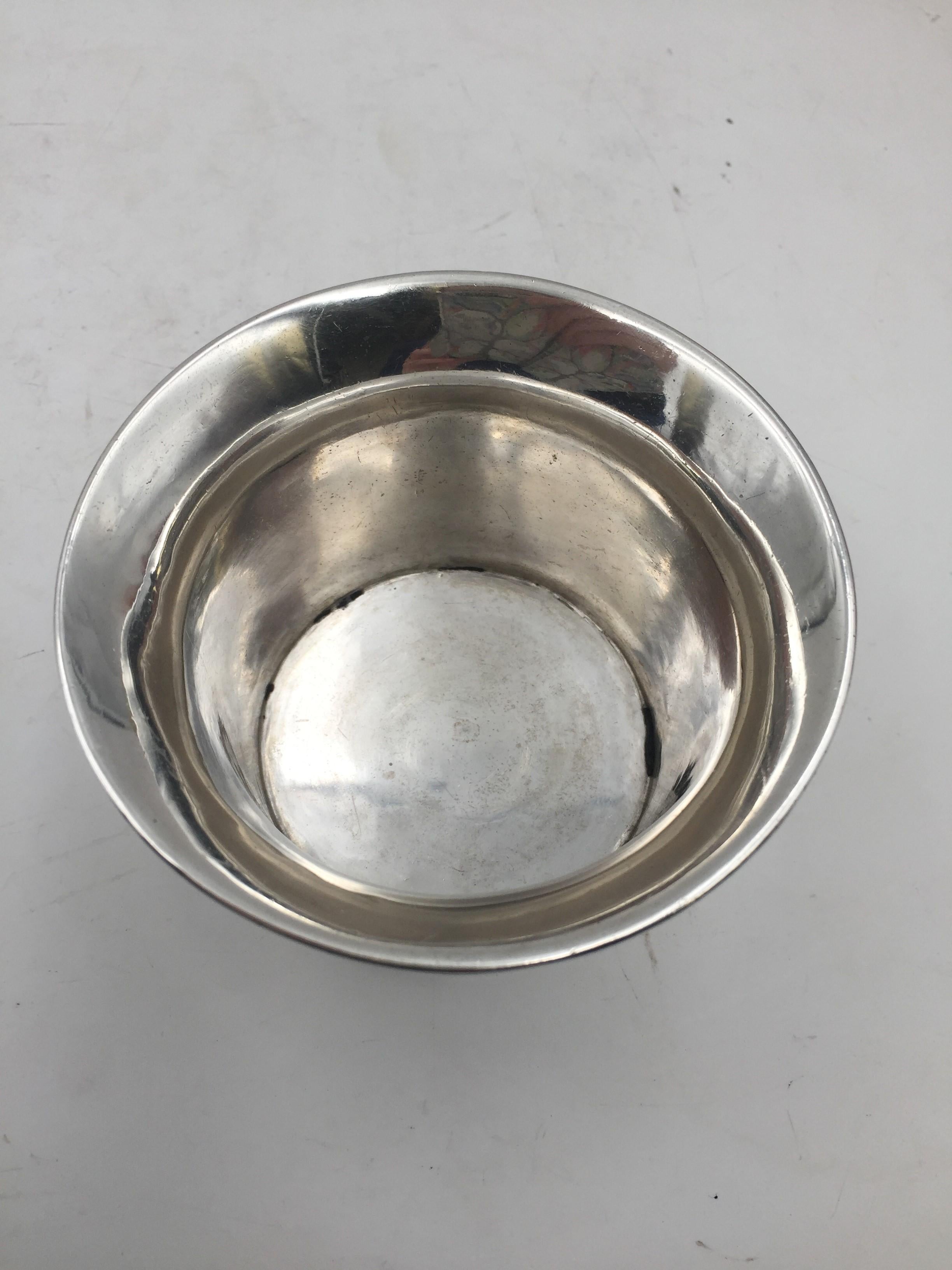 English sterling silver cup from 1760 in Georgian style by a London-based silversmith. It comes from the collection of W. Allston Flagg. It measures 4'' in diameter by 2 1/2'' in height, weighs 4.9 ozt, and bears hallmarks as shown.

According to