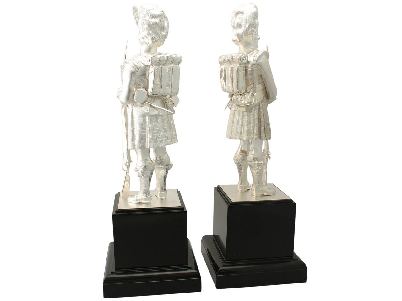 A magnificent, fine and impressive, large pair of contemporary Elizabeth II English cast sterling silver table ornaments modelled in the form of Gordon Highlanders; an addition to our diverse ornamental silverware collection.

These magnificent