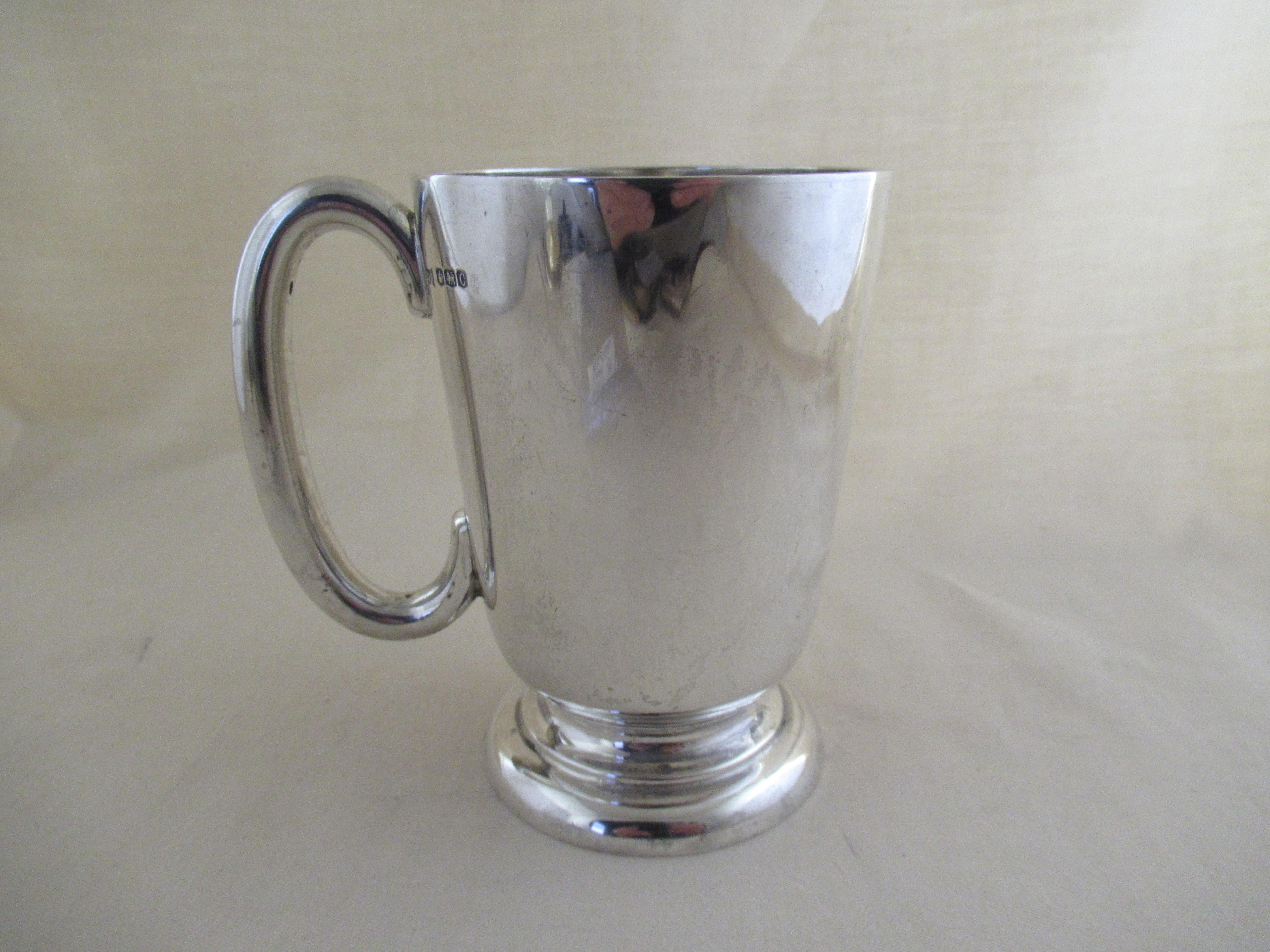 English sterling silver half pint mug made in 1945 - 77 years old
Full English hallmark for Sheffield 1945.
With the maker's mark - W & H, for Walker & Hall, Electro Works,
 Howard Street, Sheffield.

A delightful mug of traditional, tapering