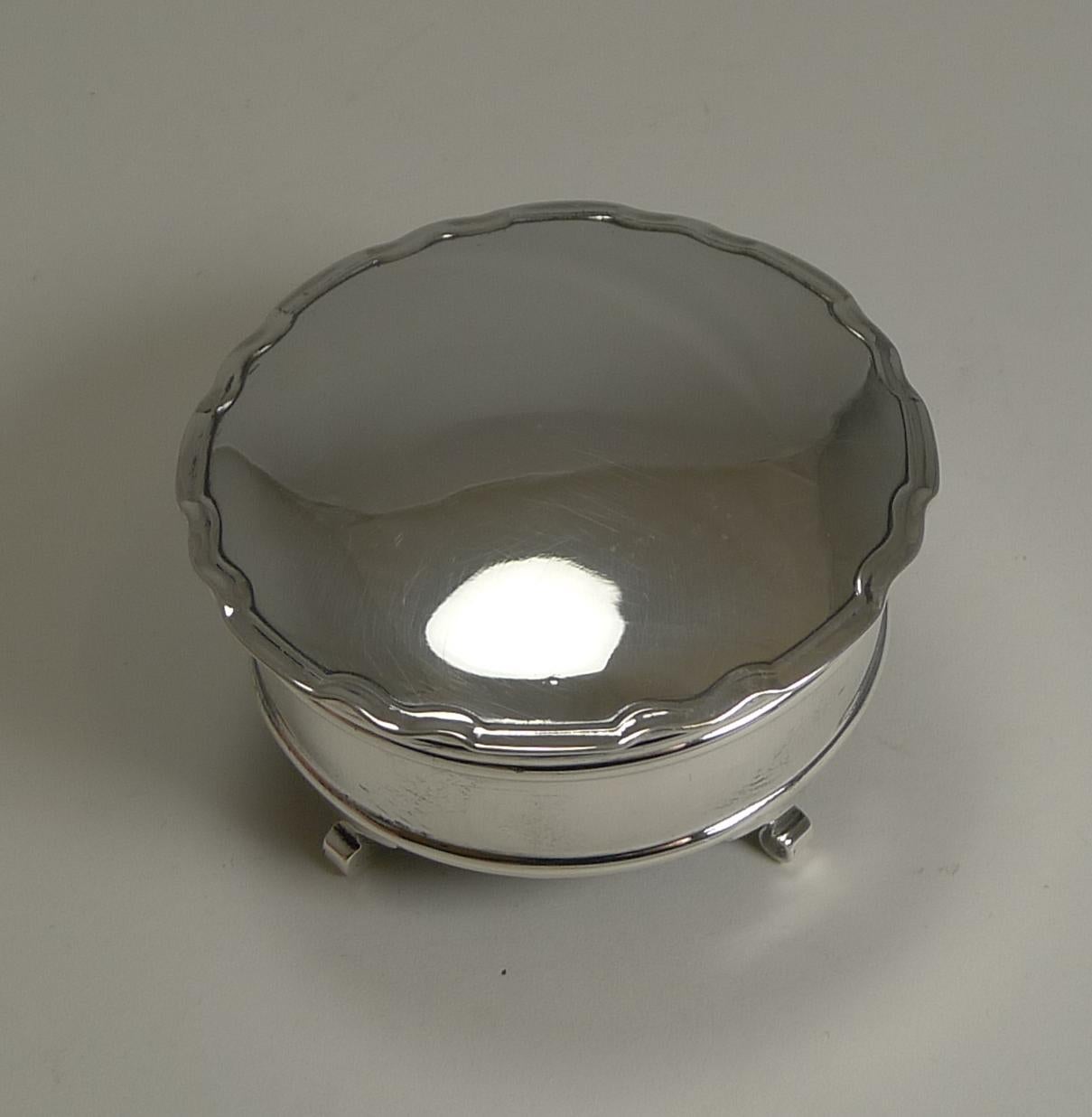 A very elegant jewellery or ring box made from English sterling silver fully hallmarked for Birmingham 1920, 98 years old. A good solid box on four handsome feet, the shaped lid with a raised border framing the slightly domed lid.

The lid fits