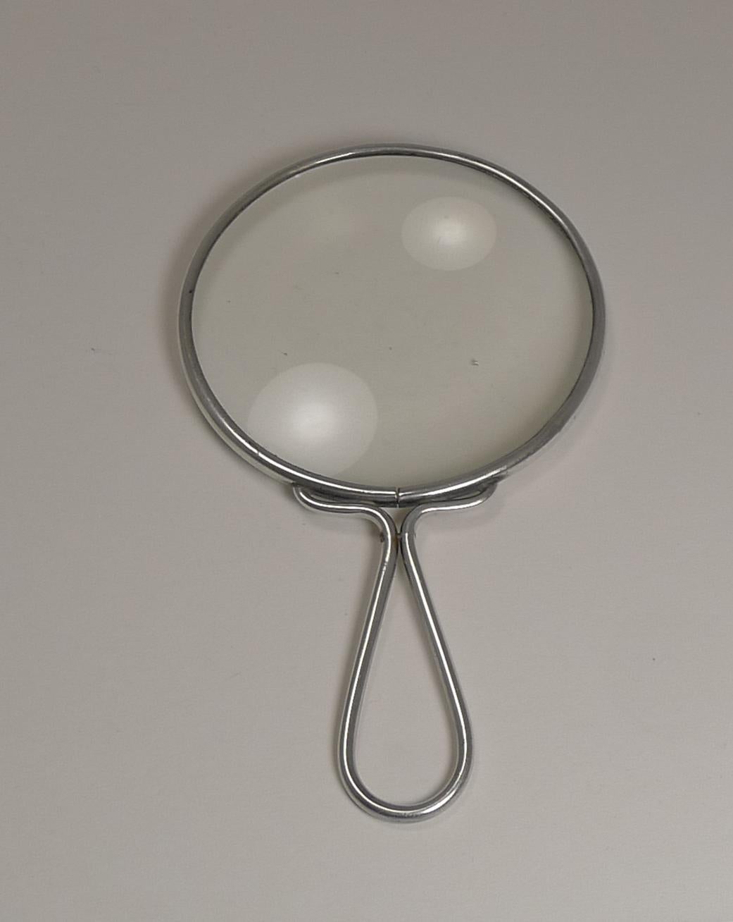 A wonderful large desk magnifying glass by the highly sought-after and collectable silversmith, Sampson Mordan and Co. Ltd.; fully hallmarked for London 1925.

The frame around the magnifier and the handle are all sterling silver. The glass is the