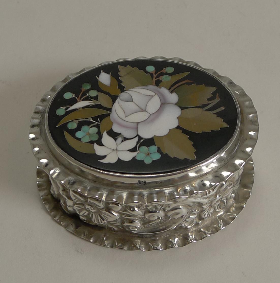 This little late Victorian sterling silver pill box is decorated with all over repousse work and crimped edges to top and bottom.

The top was inlaid with a tablet of Italian Pietra Dura, a really unusual combination and certainly a fabulous find.