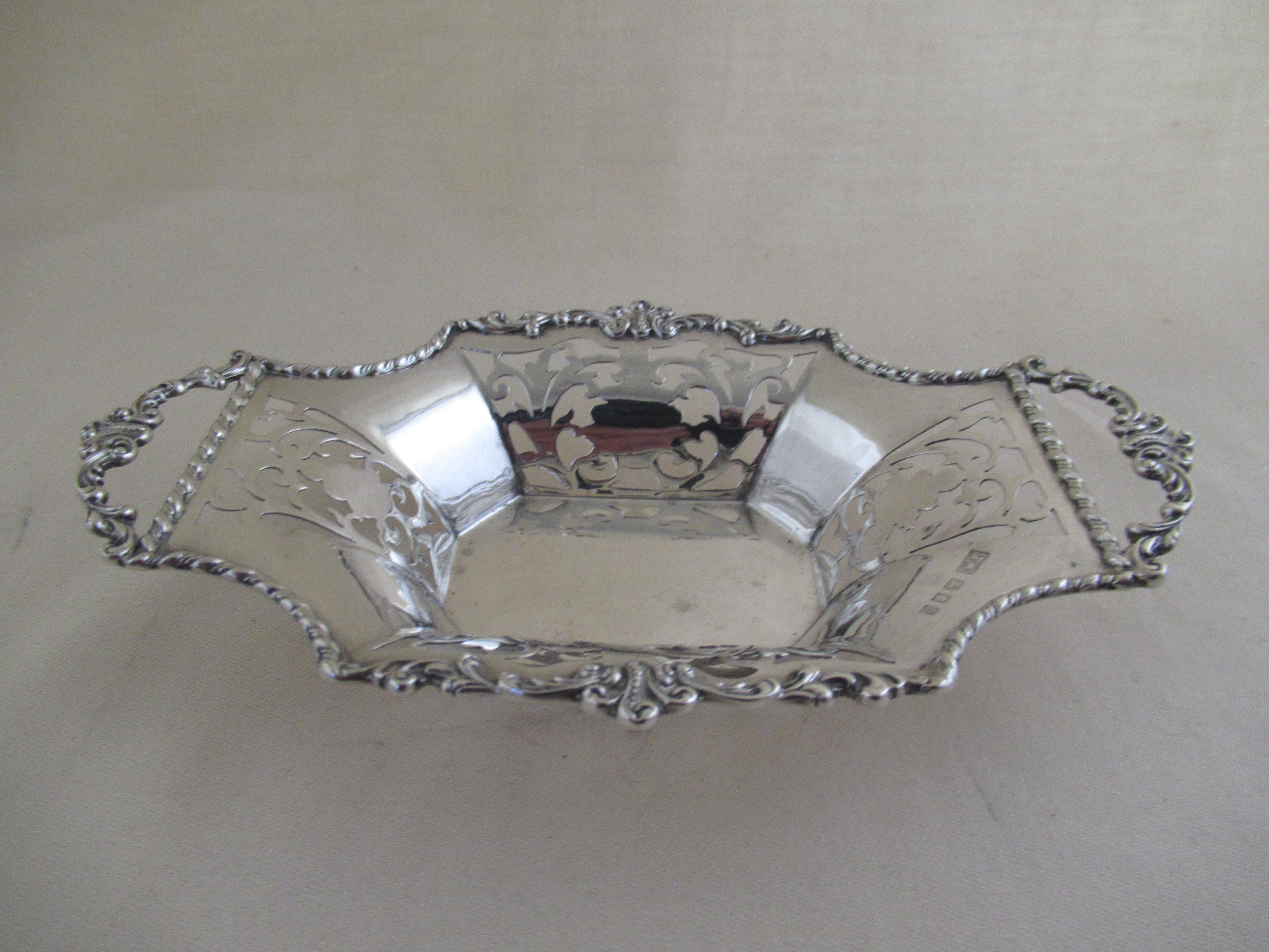 English Sterling Silver PRETTY BONBON DISH - Made in 1929
Full English hallmarks for London 1929
With the maker`s mark - Mn & Wb, for Mappin & Webb, Oxford St., London.

A beautiful dish, made with eight panel sides. Four with pierced
