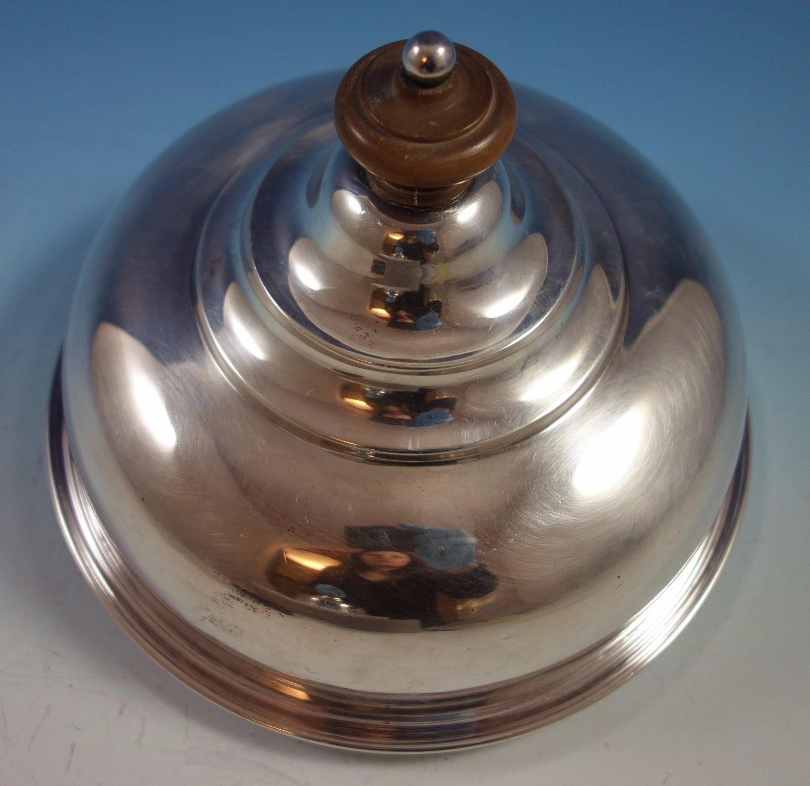Sterling silver quail / cheese dome.

English sterling
Fabulous English sterling silver small dome with a wood knob. Hallmarked for London in 1898. It measures 6 tall x 7 1/2 and weighs 18.18 ozt. It is not monogrammed and is in excellent