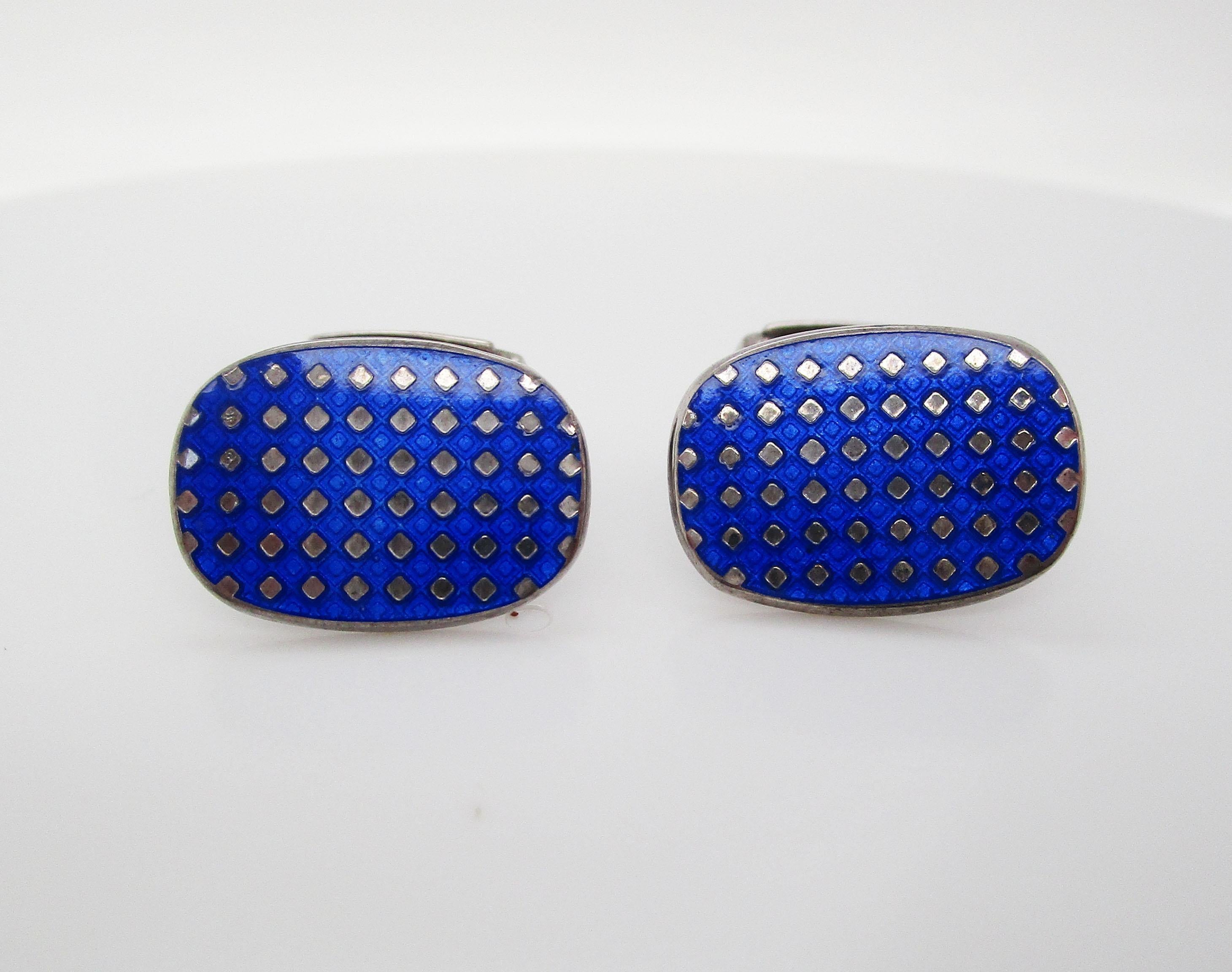 This is an incredible set of cufflinks made in England in sterling silver with gorgeous royal blue enamel panels and a negative space dot design. These links are in fantastic condition! These are the ideal staple links for the gentleman looking to