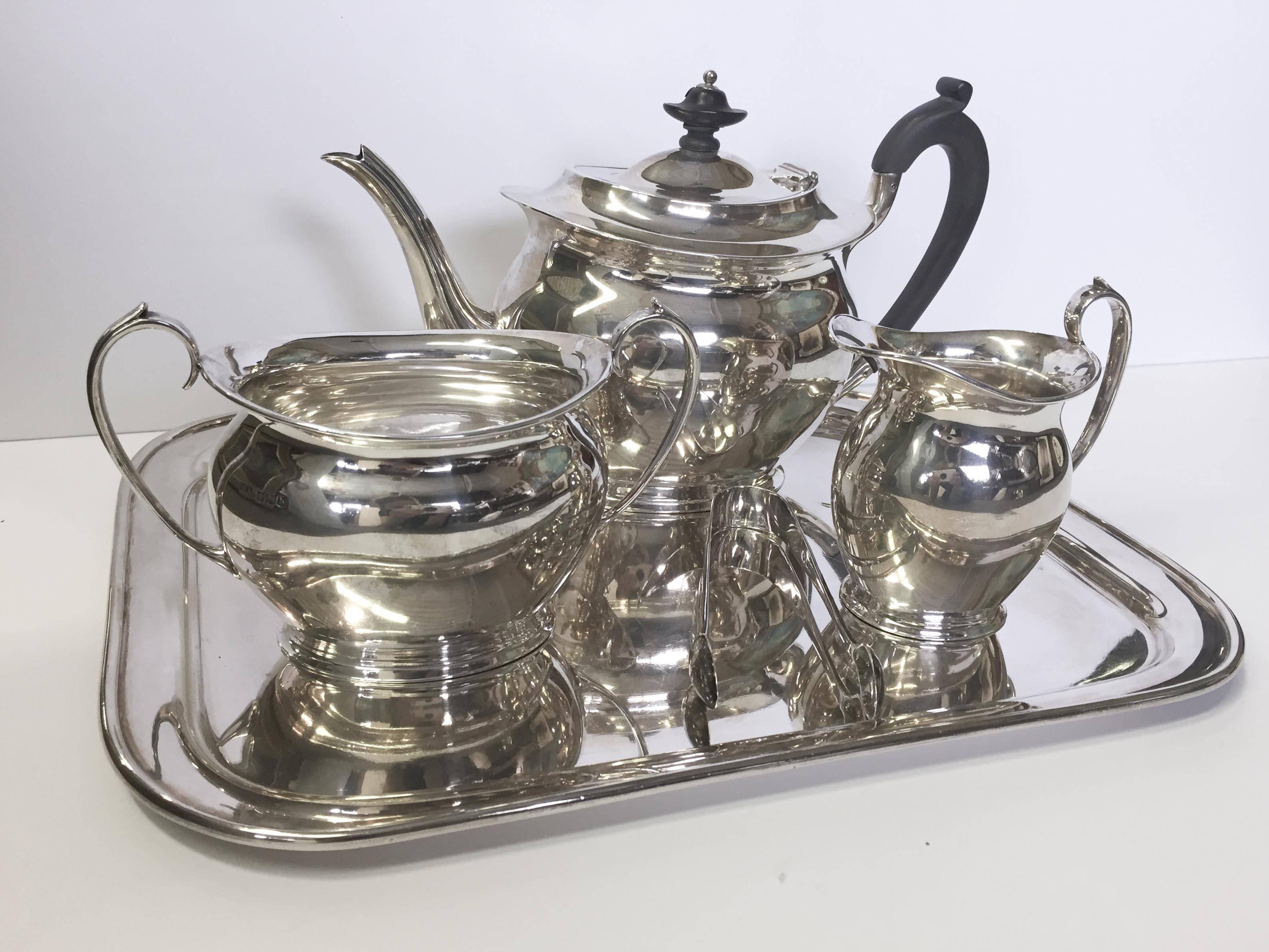 English five-piece sterling silver tea set, all pieces original to the set with the exception of the tongs, which are of the age and style. Sheffield marked.
