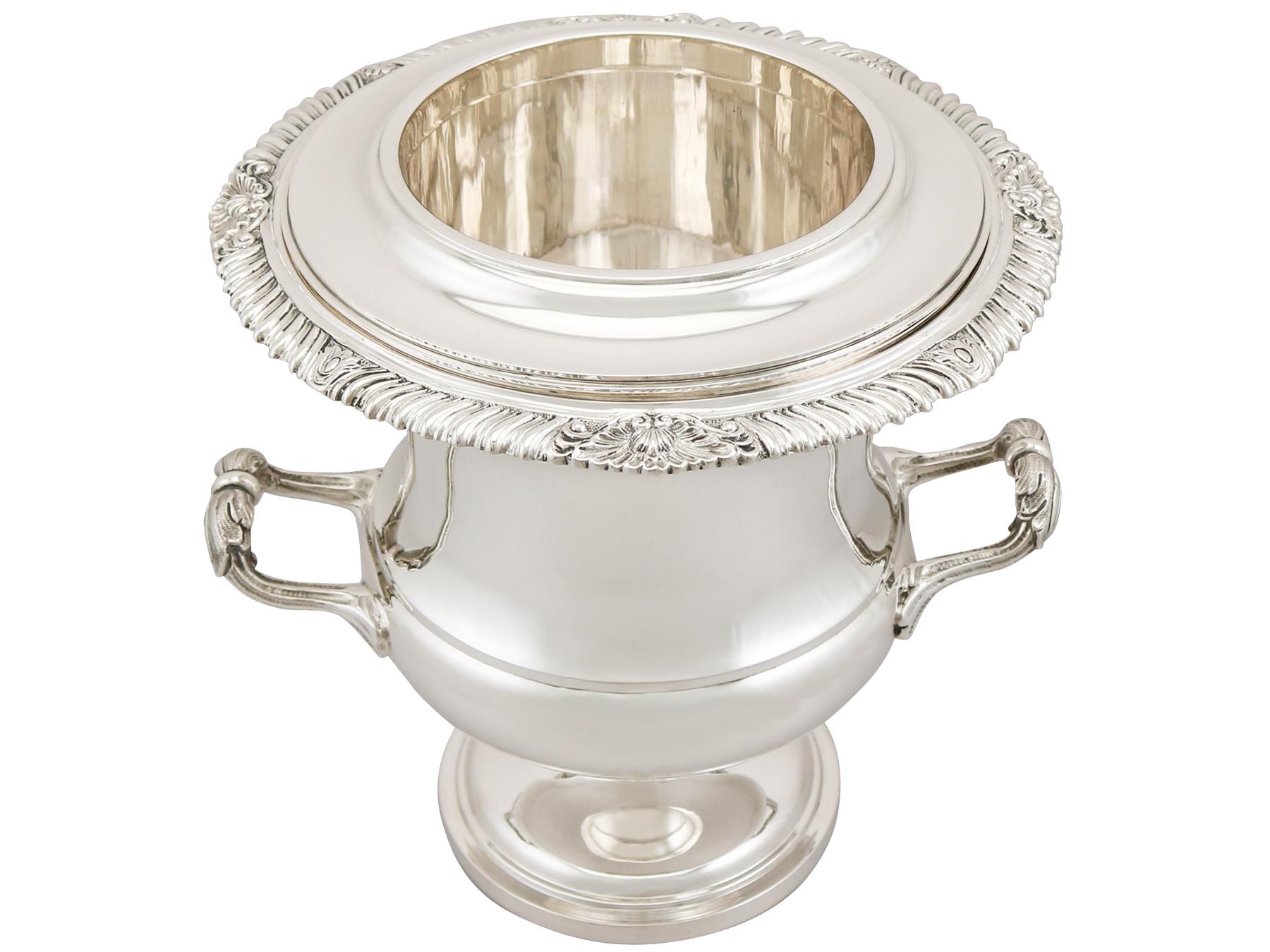 A magnificent, fine and impressive vintage Elizabeth II English sterling silver wine cooler made by Garrard & Co Ltd; an addition to our presentation silverware collection.

This magnificent vintage Elizabeth II sterling silver wine cooler has a