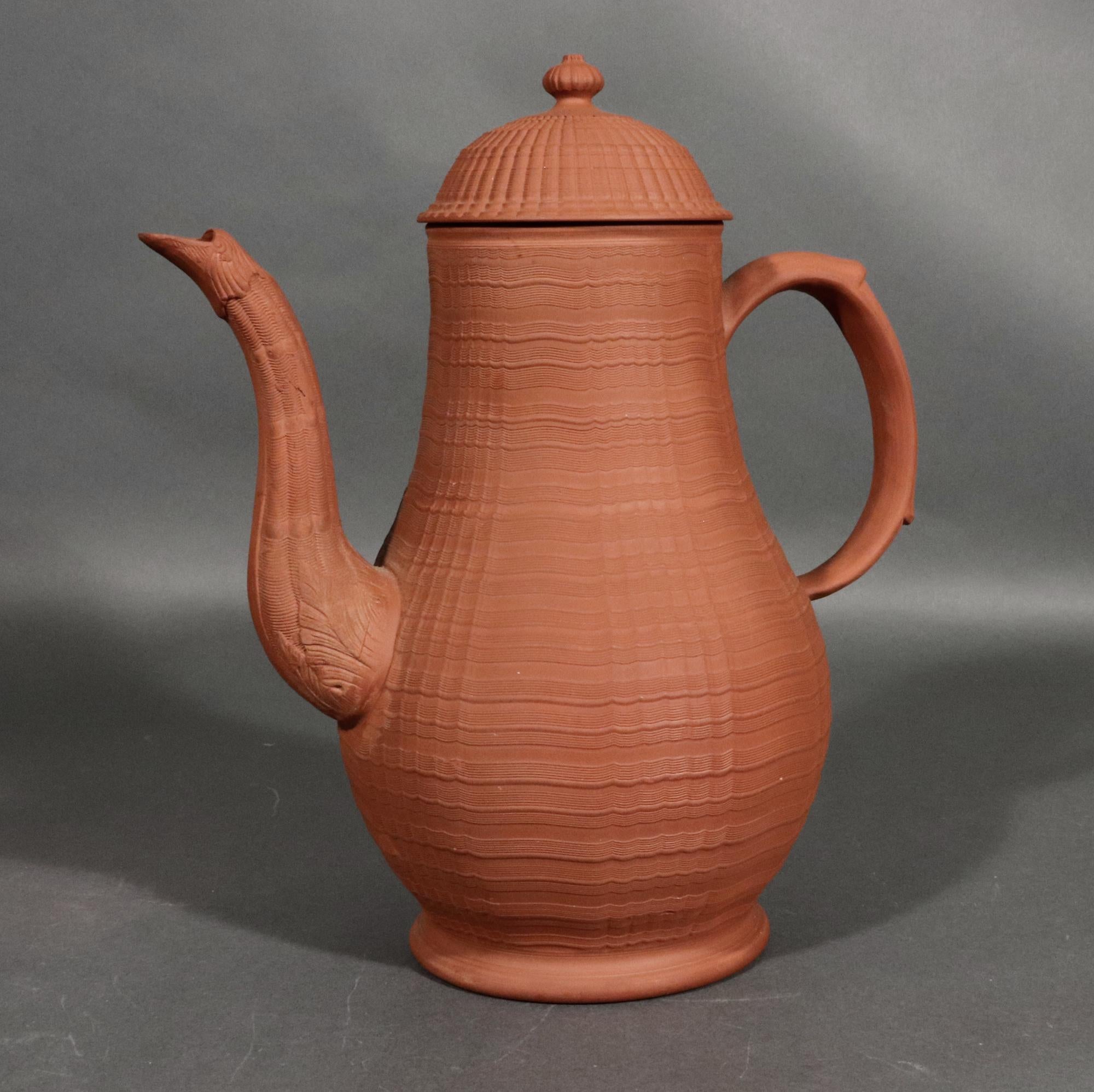English Stoneware Pottery Redware Stoneware Engine Turned Coffeepot,
Staffordshire,
Circa 1765

A Staffordshire redware stoneware coffeepot and cover with an engine-turned body and cover. The cover with an acorn finial.  The spout in the form of a