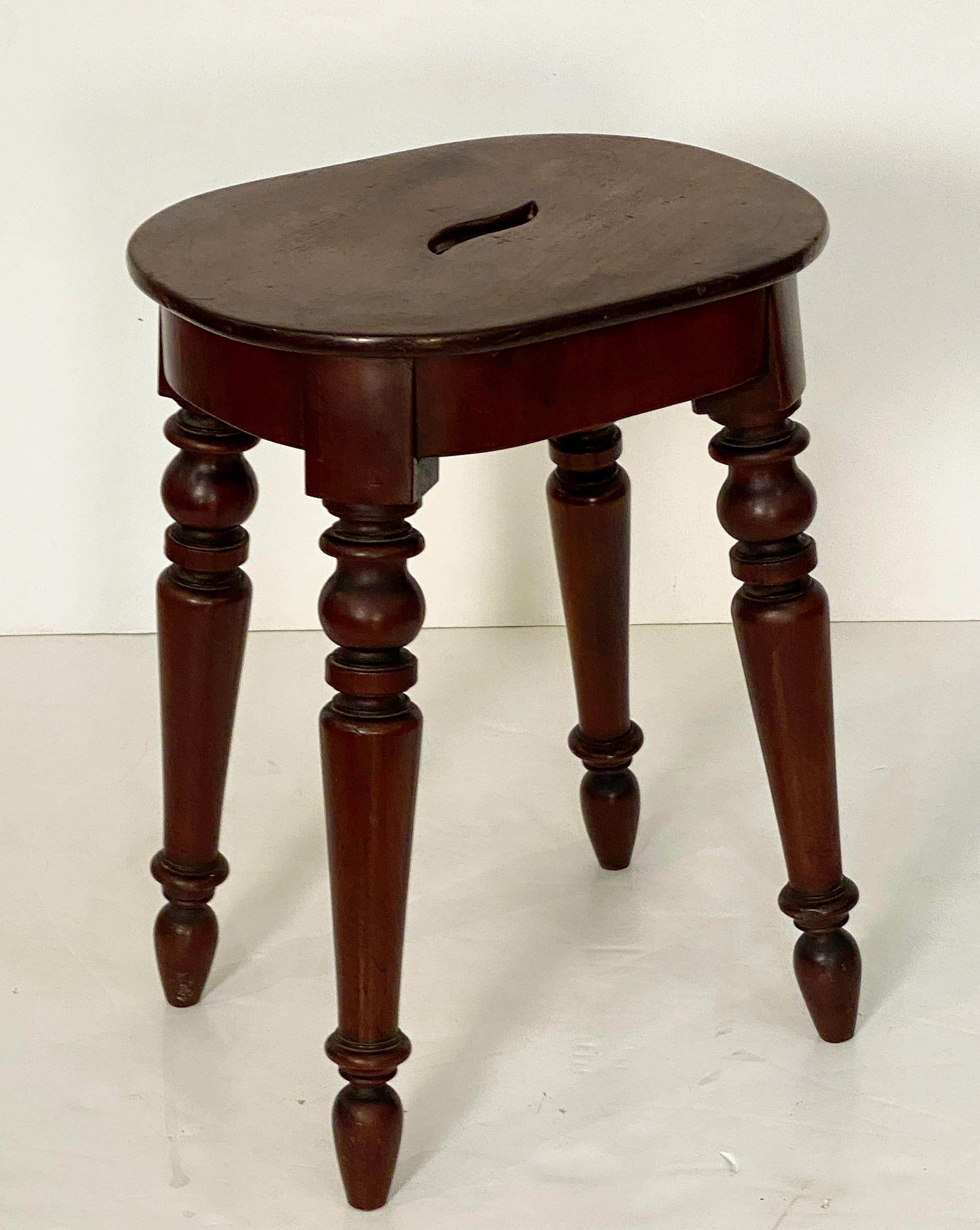 Patinated English Stool of Mahogany with Oval Seat and Turned Legs For Sale