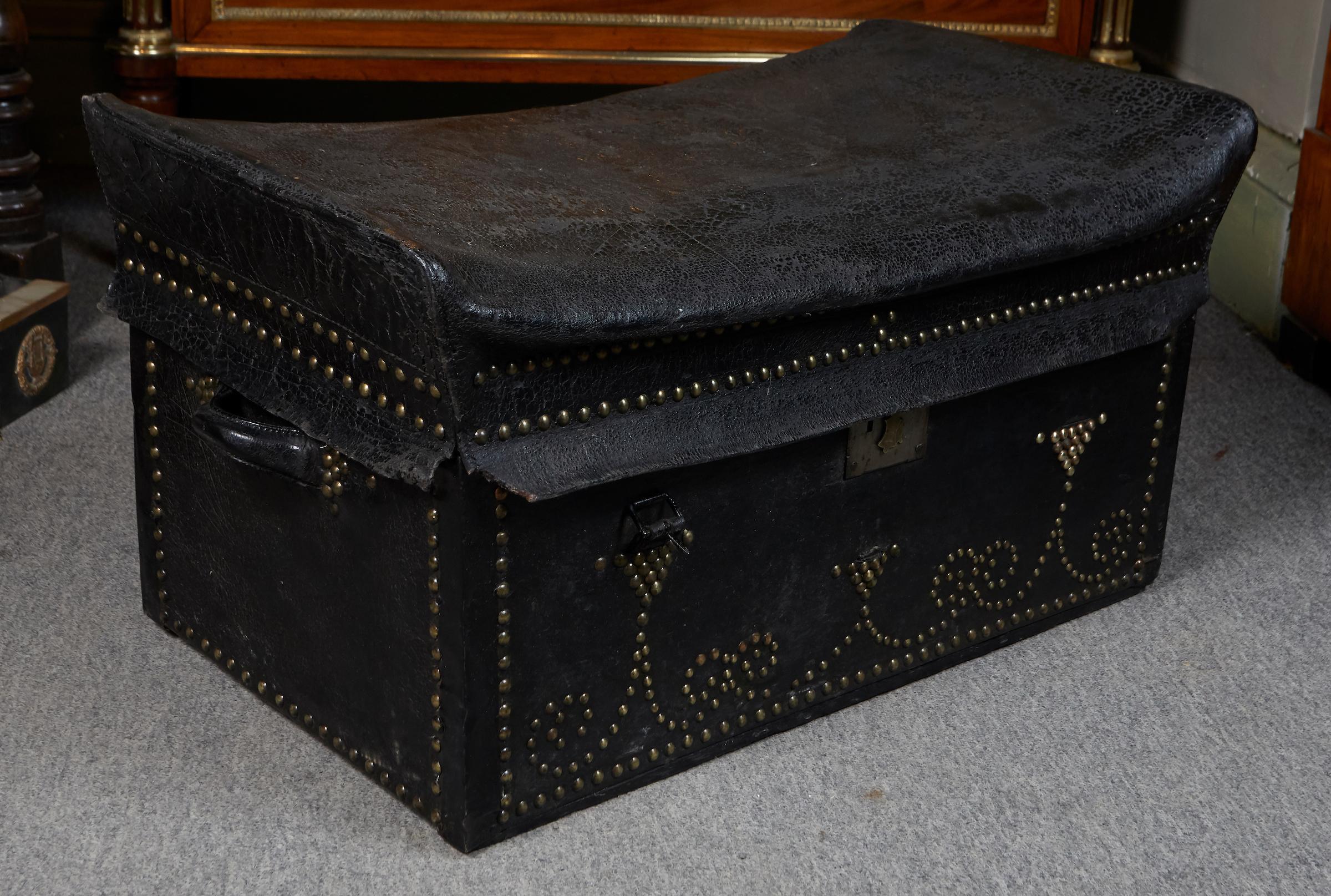 English studded black leather coach trunk, brass lock key hole stamped VR patent for Victoria Regina with a crown.