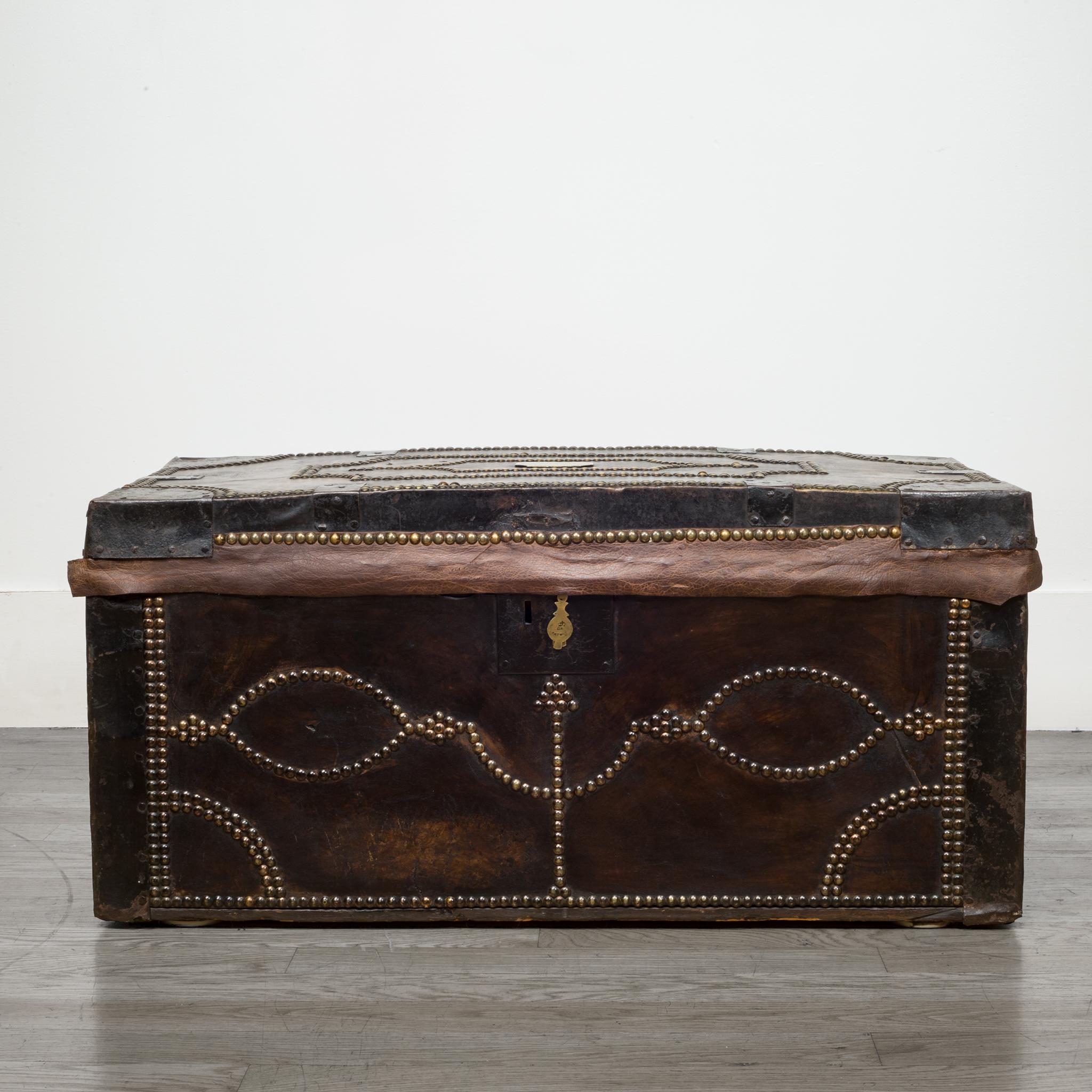 About

This is an original English document chest. This piece is made of oak, stretched leather, steel handles and brackets and covered in brass studs. A brass plaque on the top is engraved 