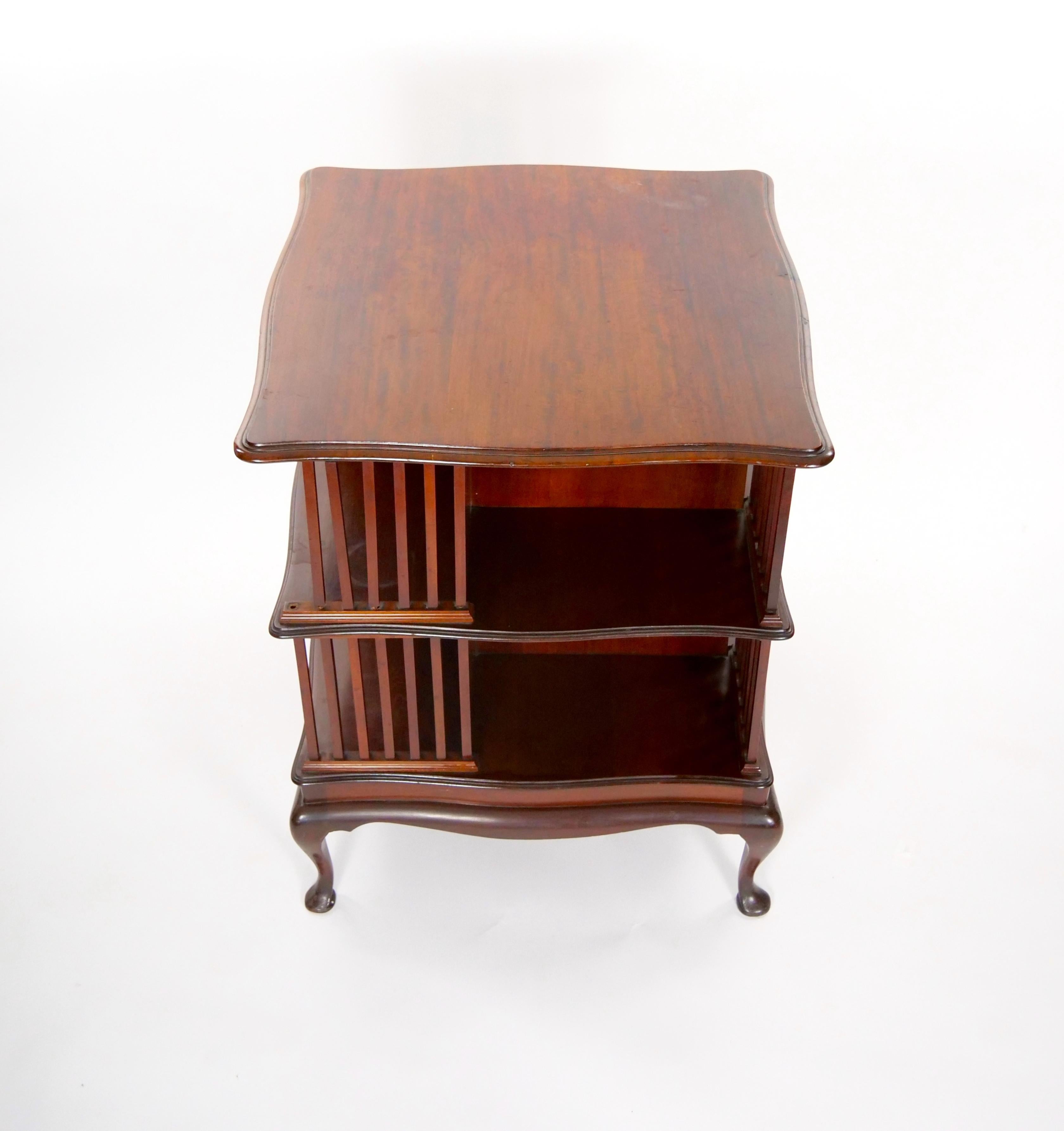 Step into the charm of English antiquity with this exquisite revolving bookcase/shelf, exquisitely crafted in stained mahogany wood. The rich, warm tones of the wood evoke a sense of timeless elegance and sophistication. Designed with practicality