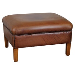 English-style leather ottoman in cognac-colored leather.