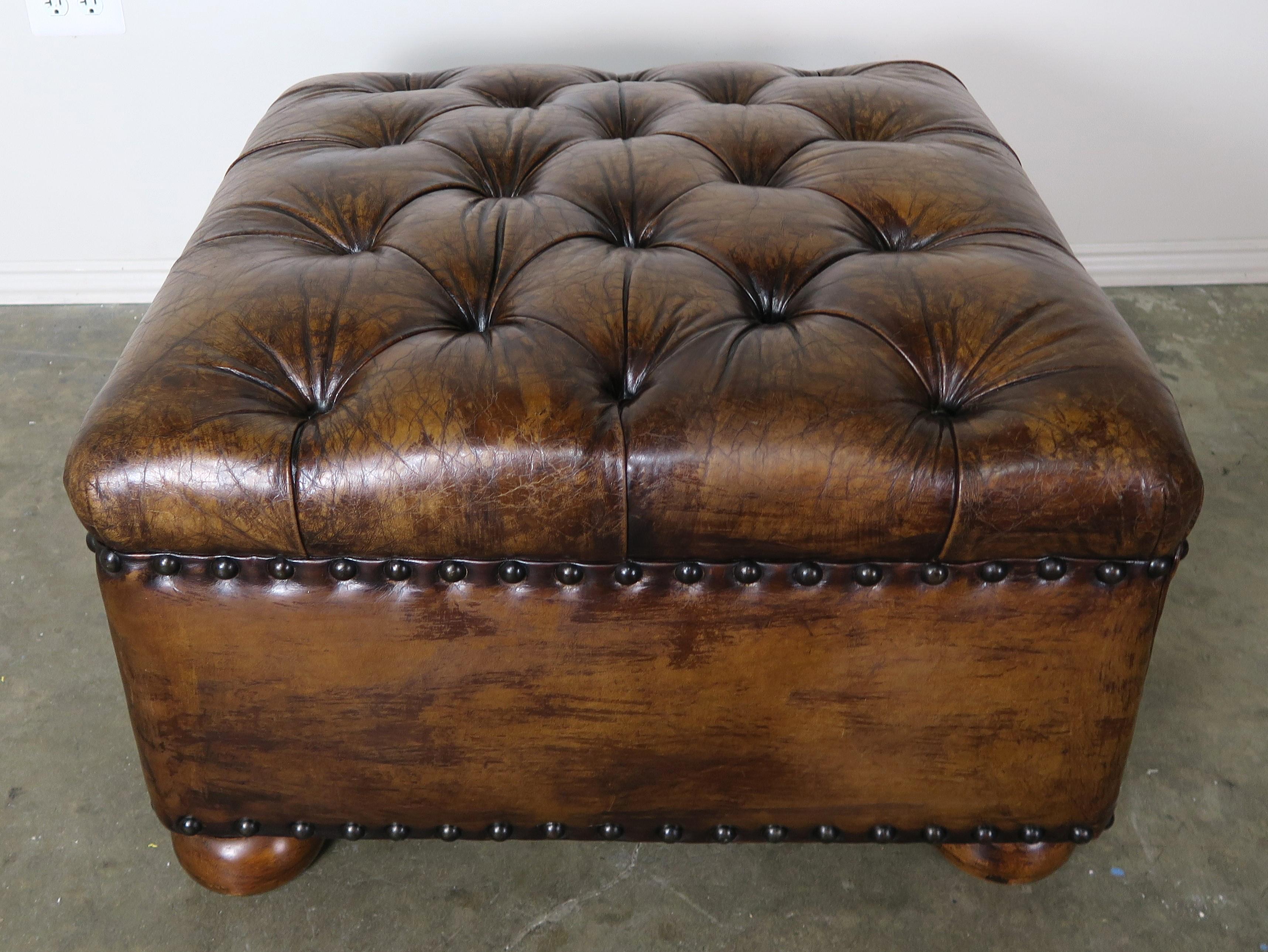 English style leather tufted bench with double row of nailhead trim detail. The bench stands on four simple bun feet. A great accent piece for any room. You can even put a tray on it and use it as your coffee table.